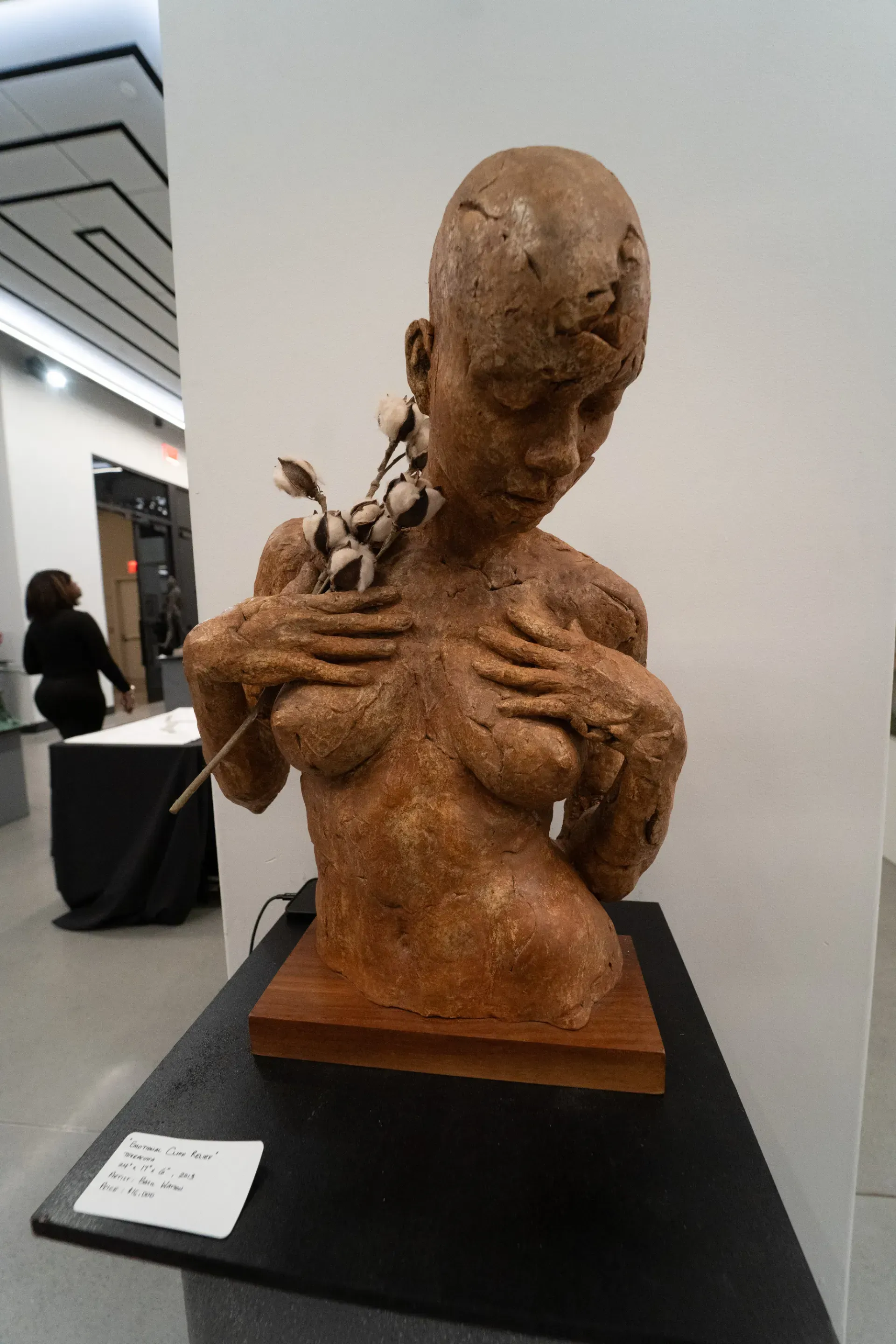 A statue of a woman is on display in a museum