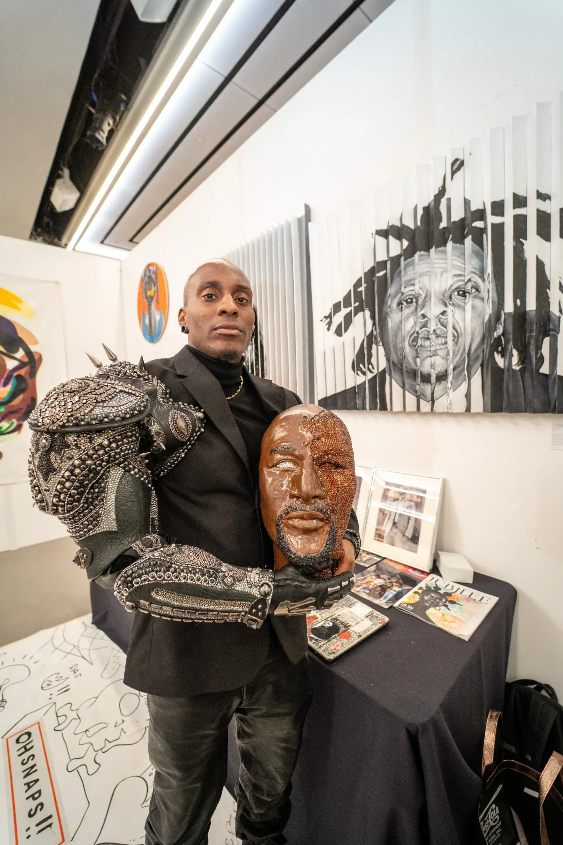 A man in a suit is holding a statue of a man 's head.