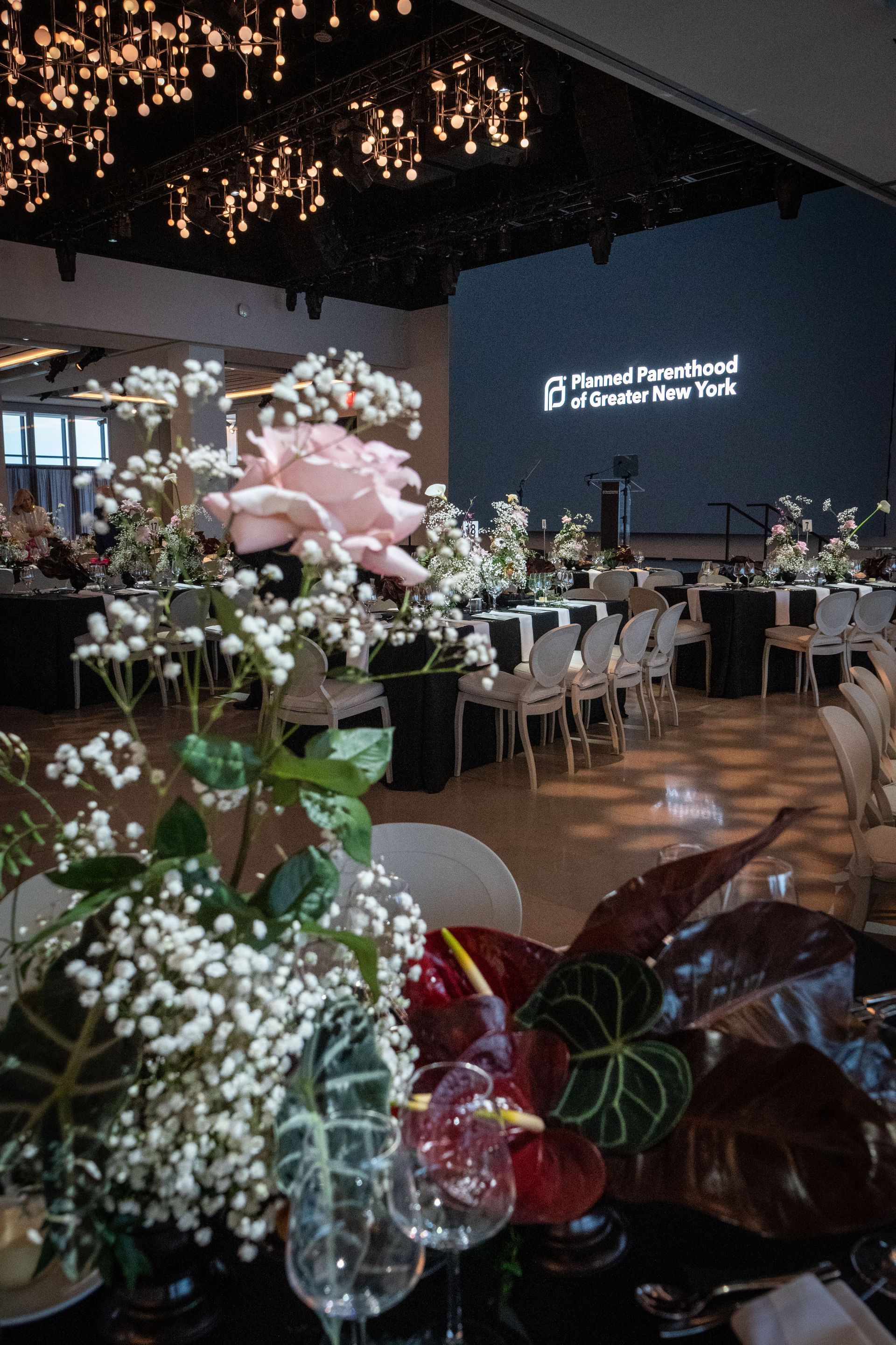Planned Parenthood Event at The Glasshouse - photo of a room filled with tables and chairs and flowers .
