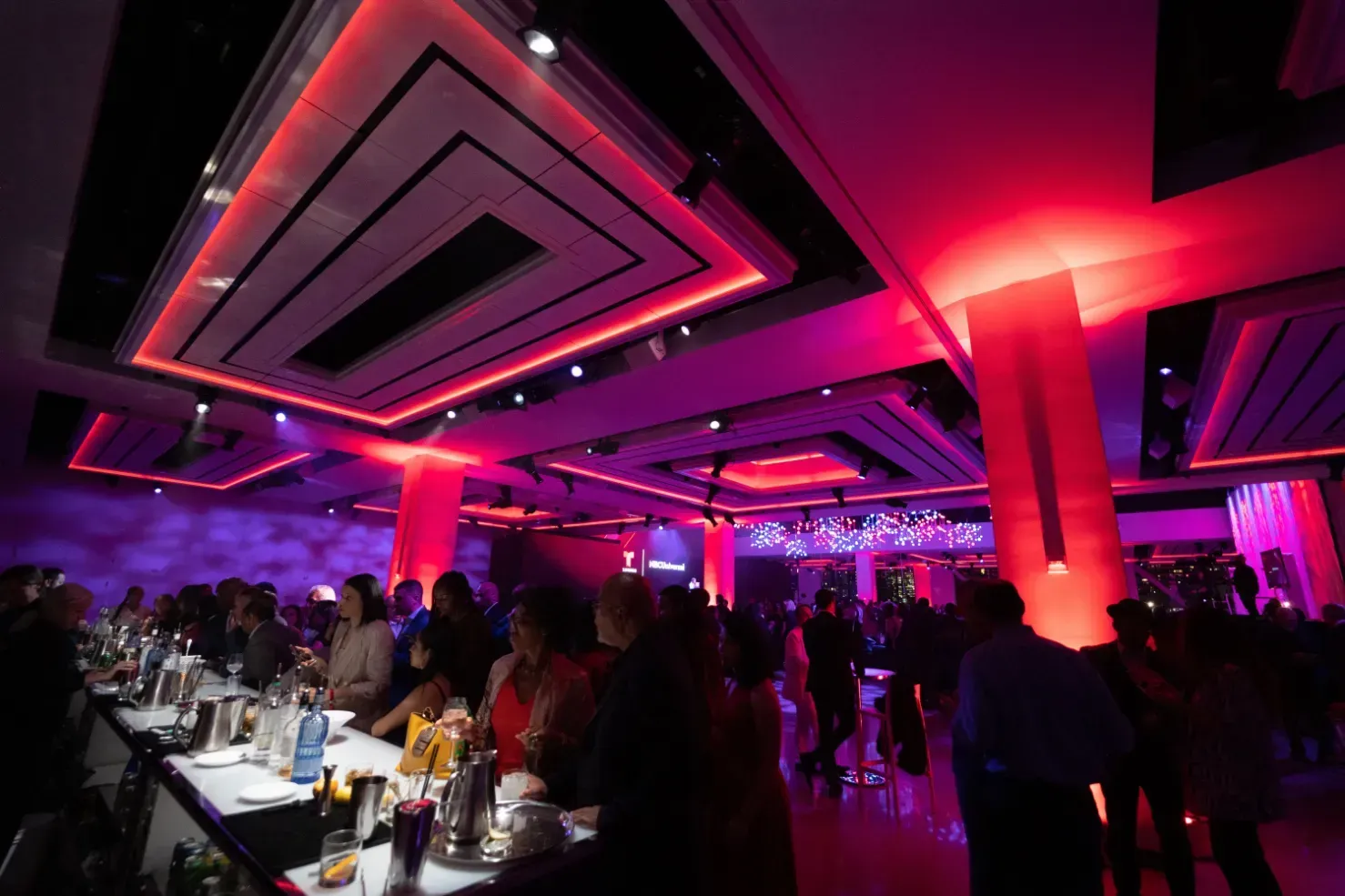 A large room with purple lights on the ceiling