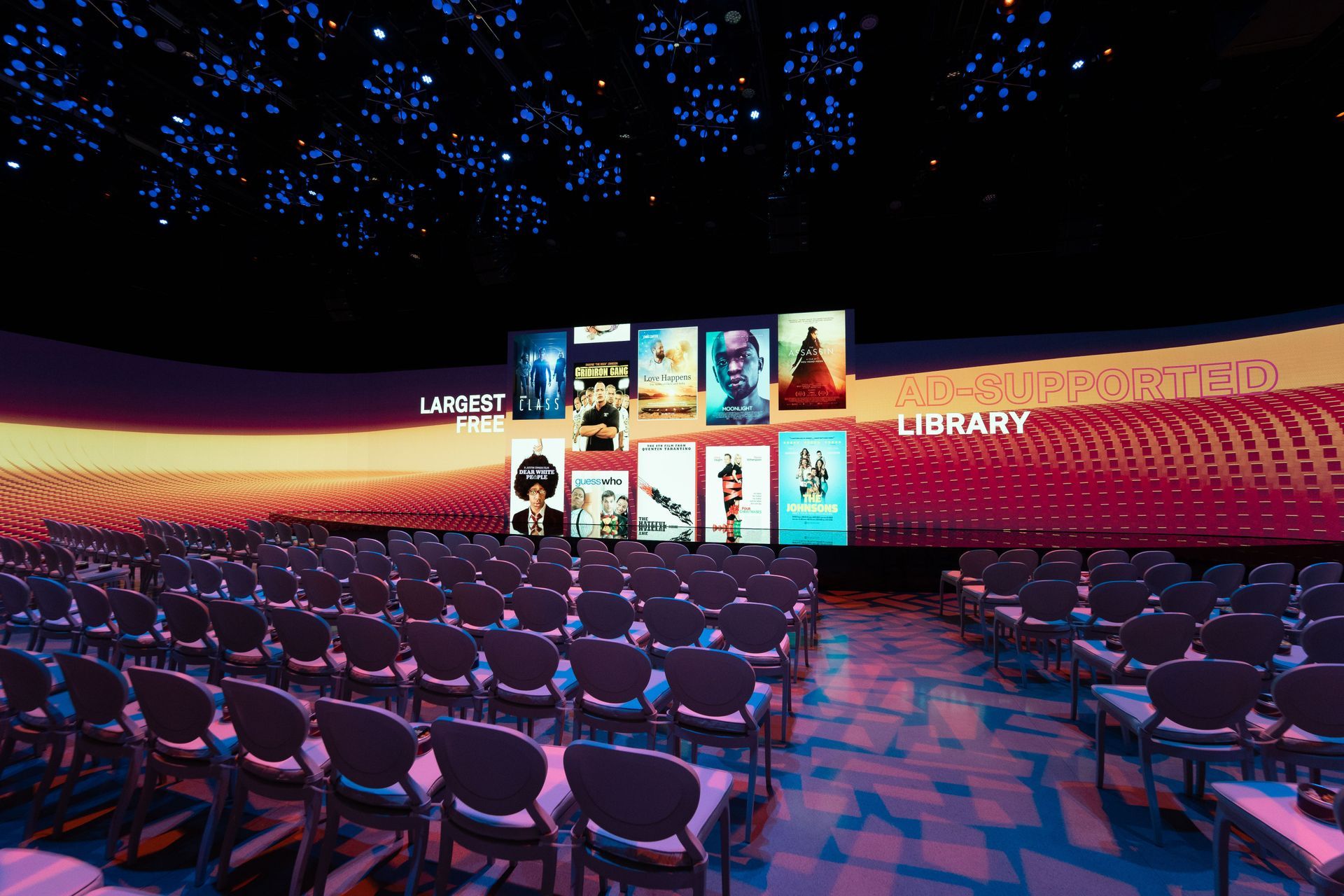 an empty auditorium with a large screen that says library on it