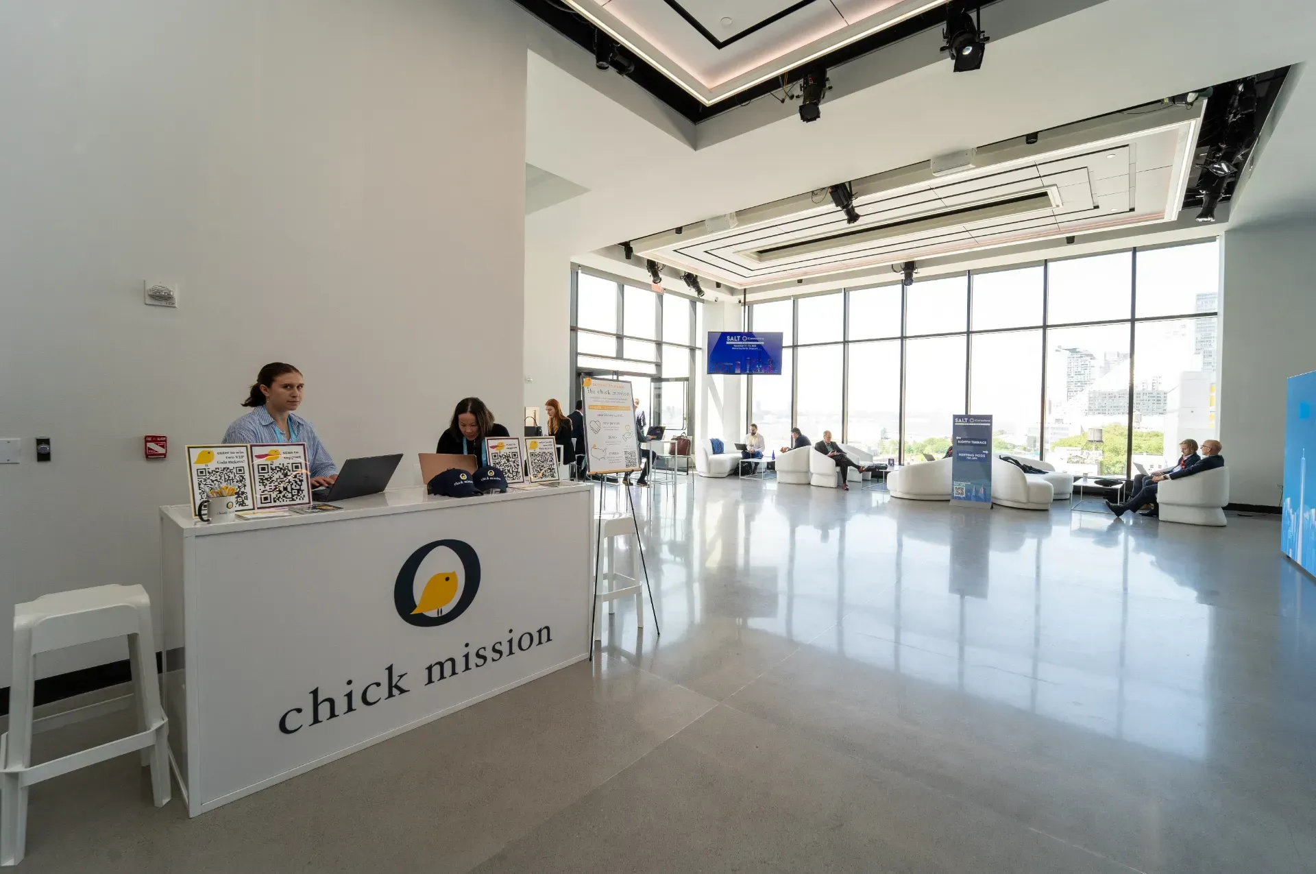 A group of people are sitting at a table in a lobby.