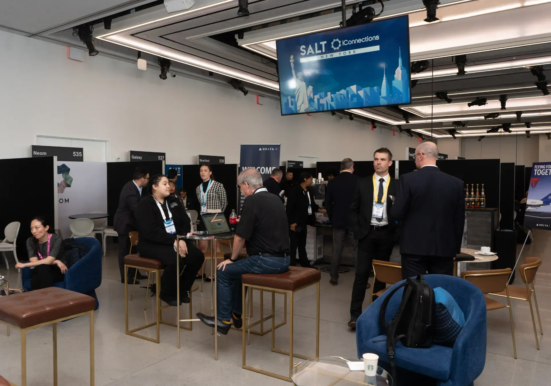 A group of people are sitting at tables in a large room.