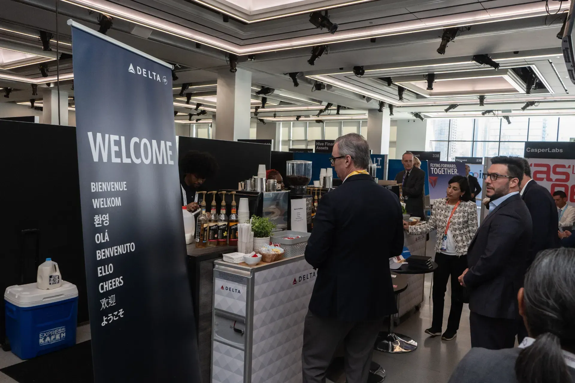 A group of people are standing around a welcome sign