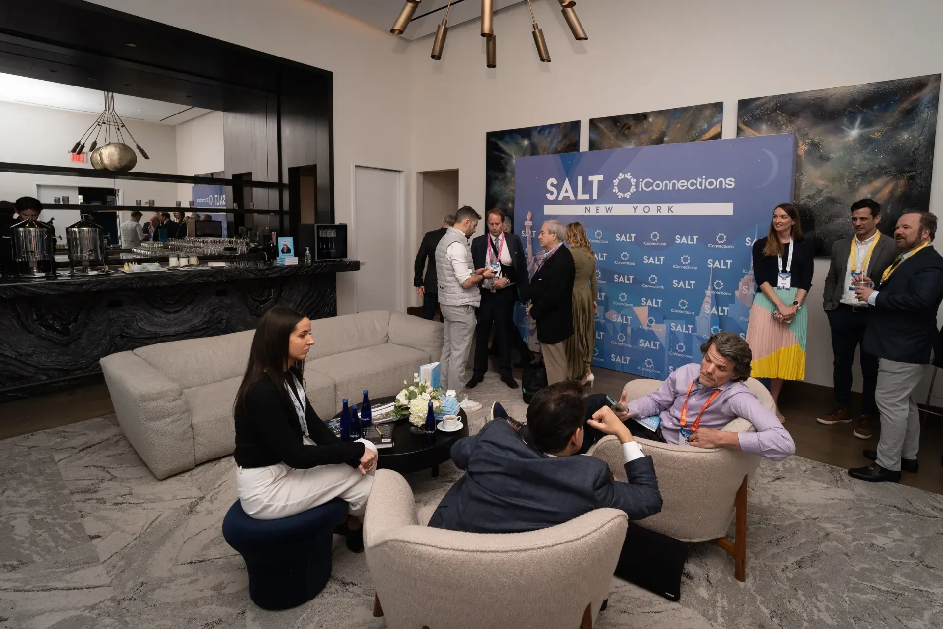 A group of people are sitting around a table in a living room.