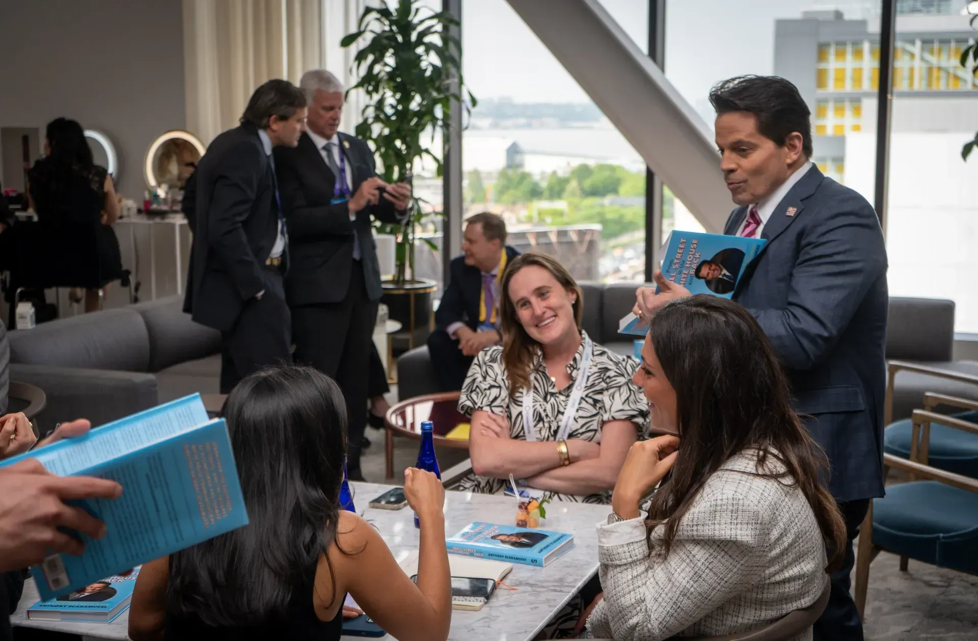 A group of people are sitting around a table in a room.
