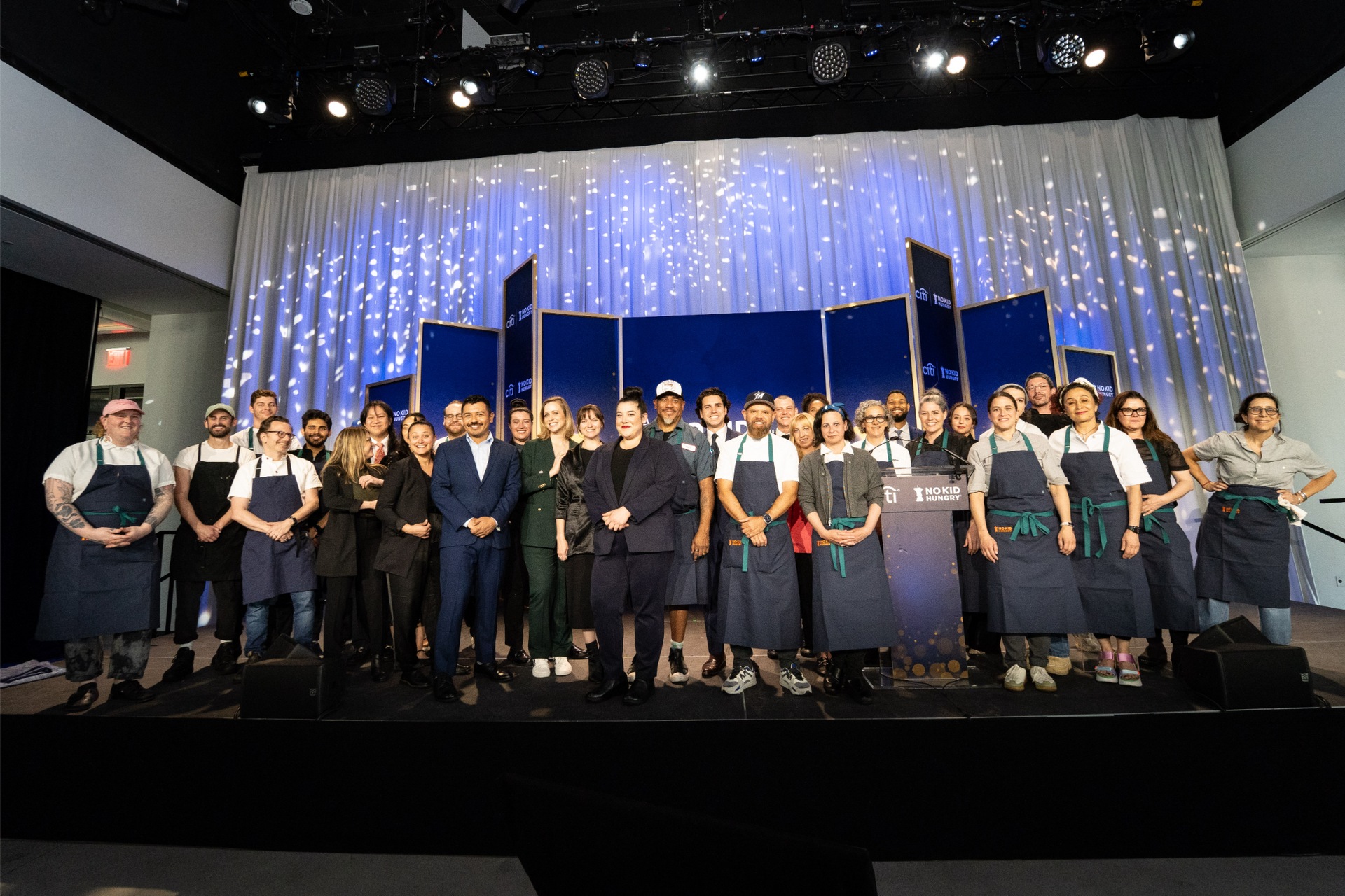 A large group of people are standing on a stage.