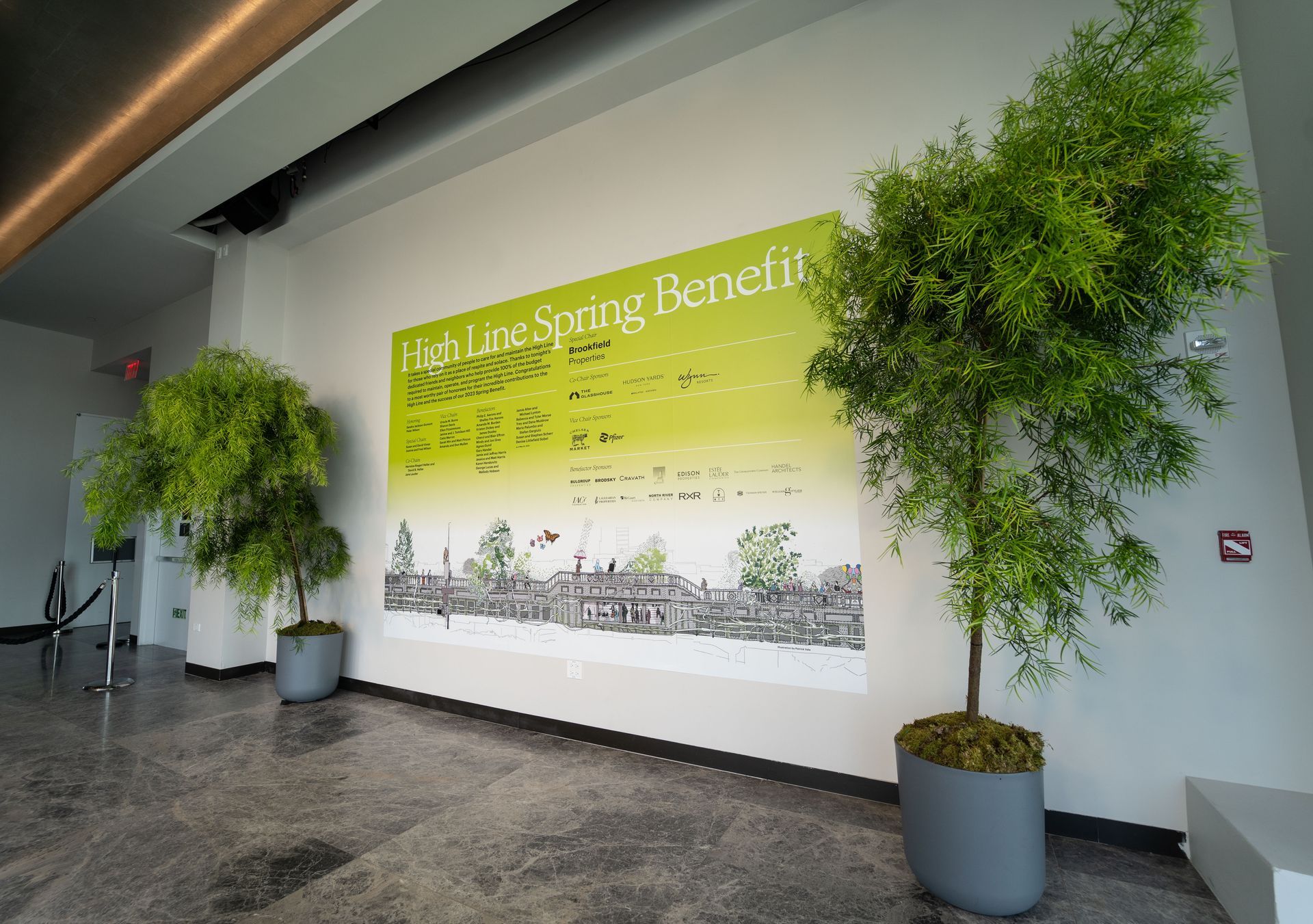 High line gala at The Glasshouse - a lobby with trees and a sign that says cash lane spring benefit