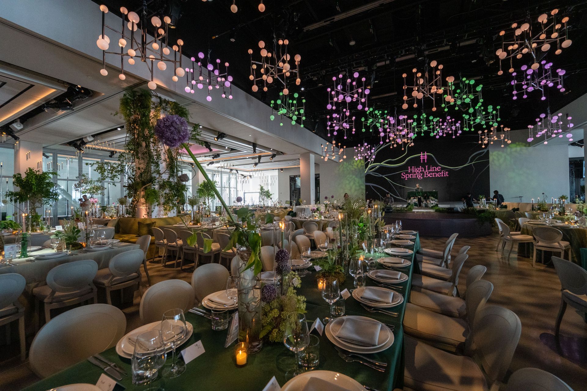 High line gala at The Glasshouse- a large room filled with lots of plants and a waterfall .