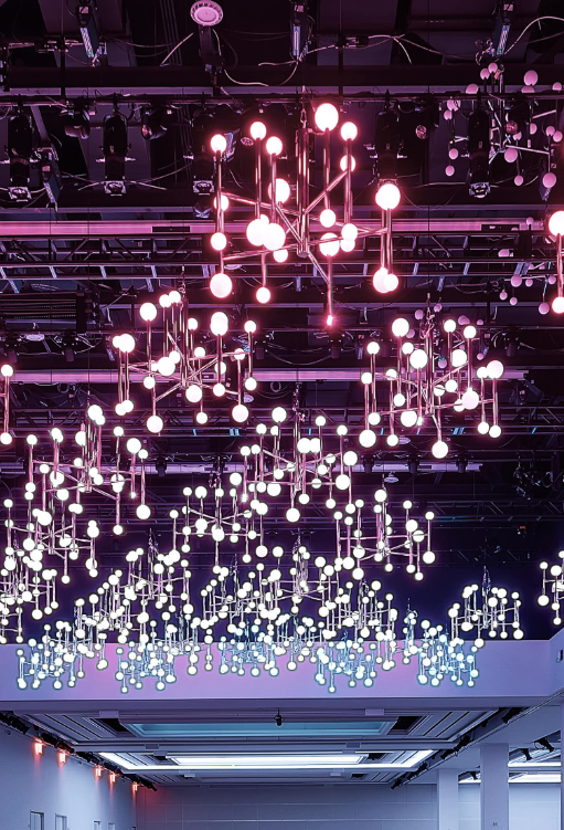 A room with a lot of lights hanging from the ceiling