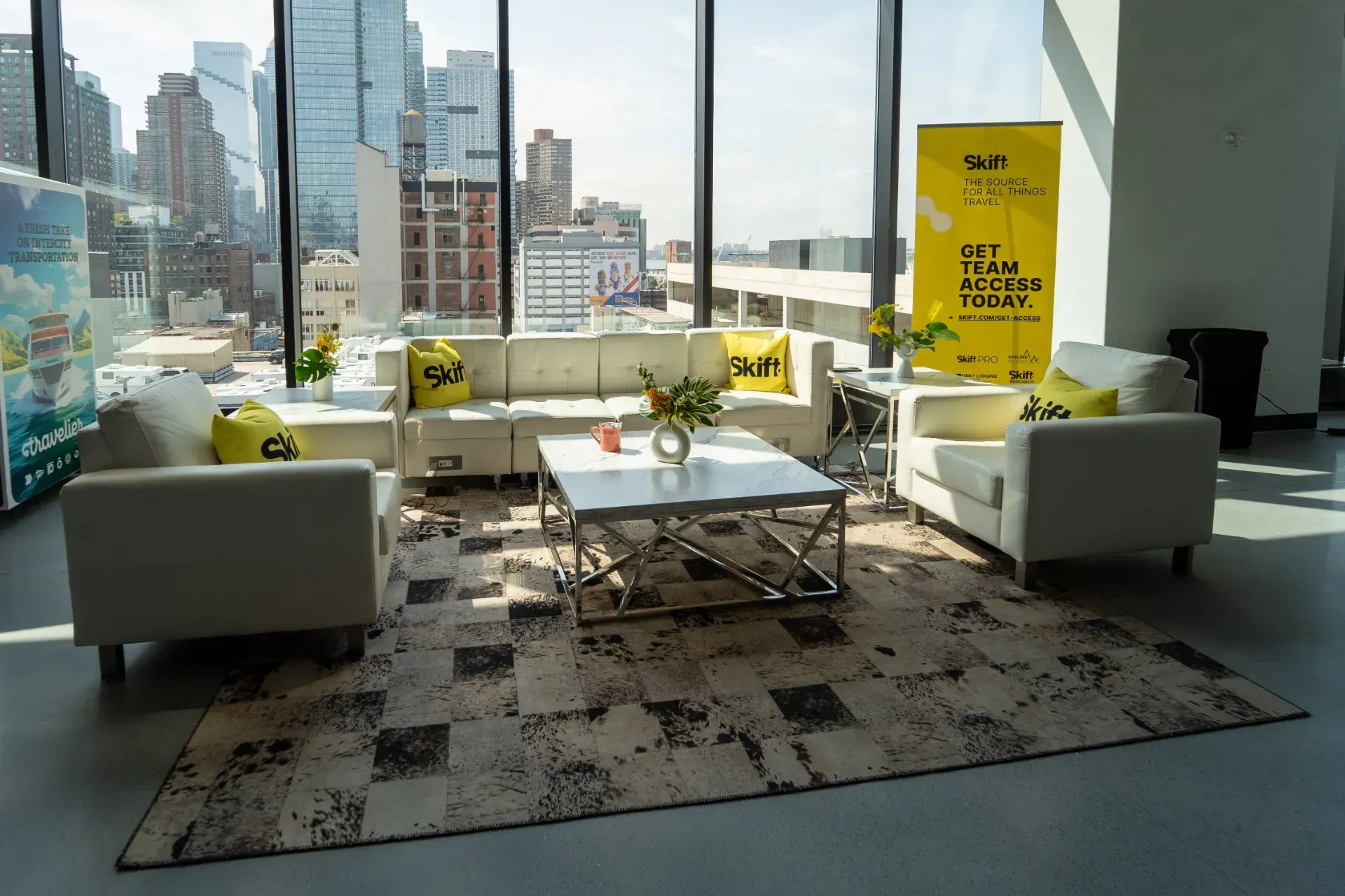 A living room with a couch , two chairs , a coffee table and a rug.
