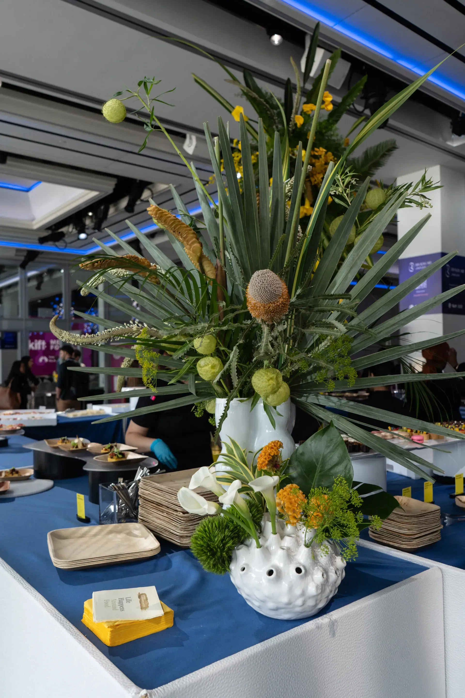 A buffet table with a vase of flowers on it