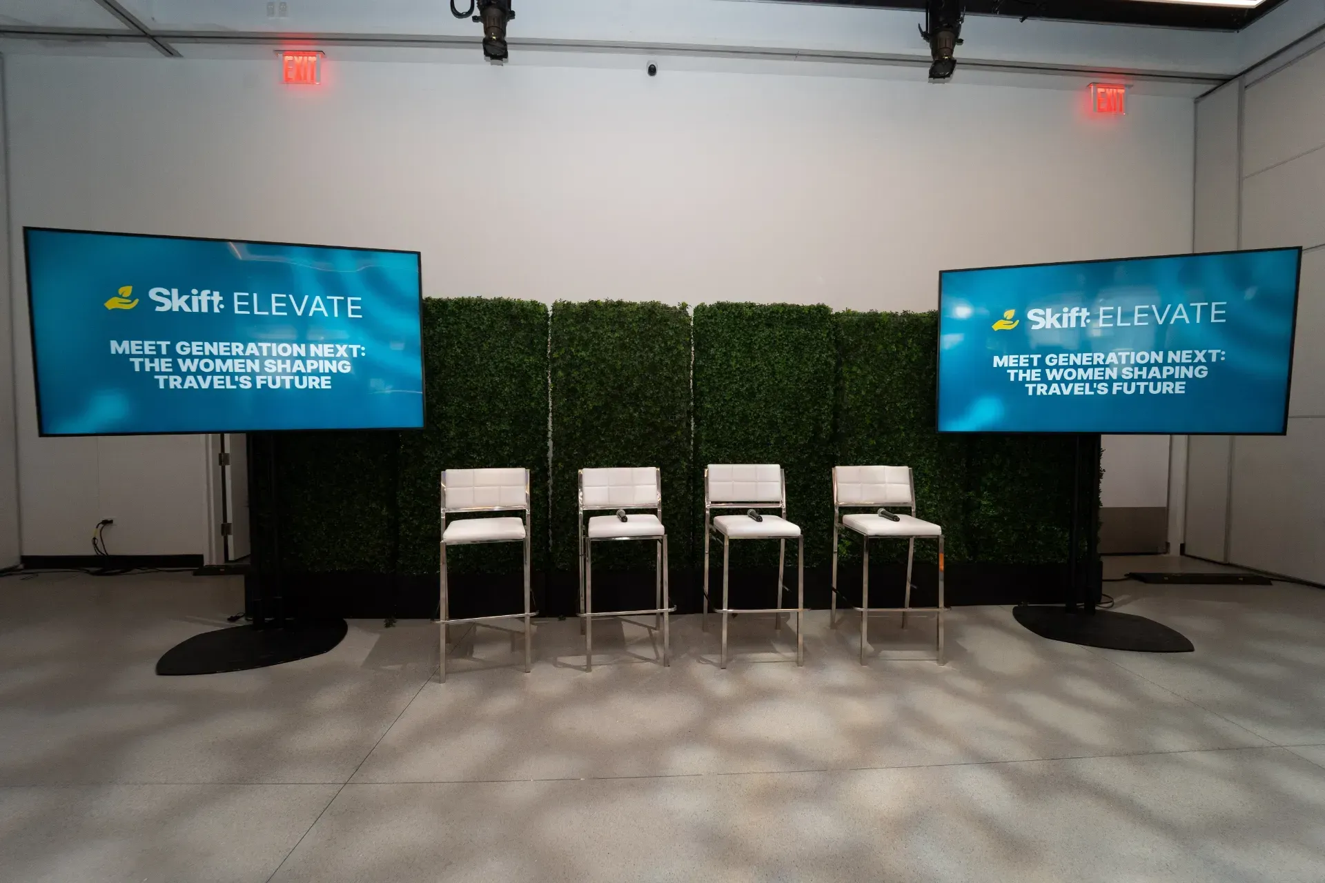 A row of chairs in front of two screens that say skill elevate