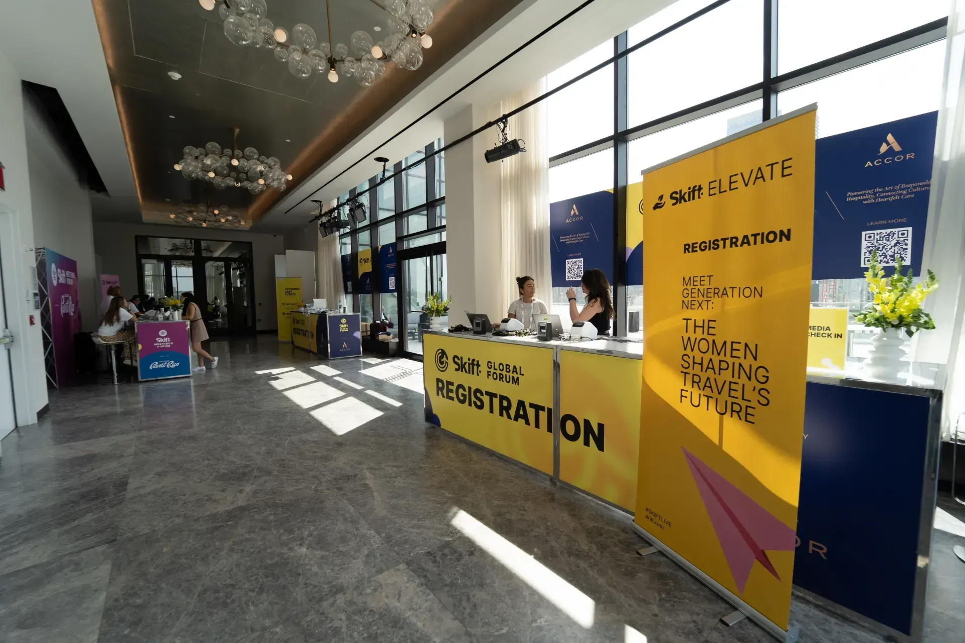 A row of chairs in front of two screens that say skill elevate