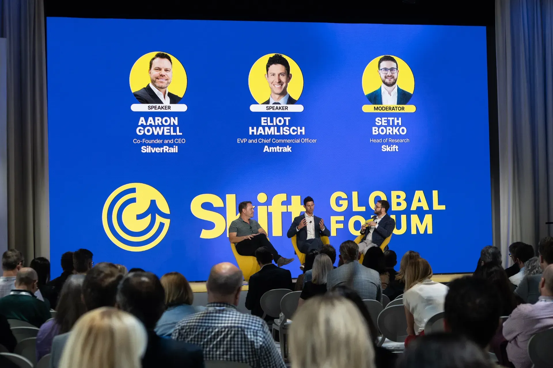 A group of people are sitting in front of a screen that says stiff global forum