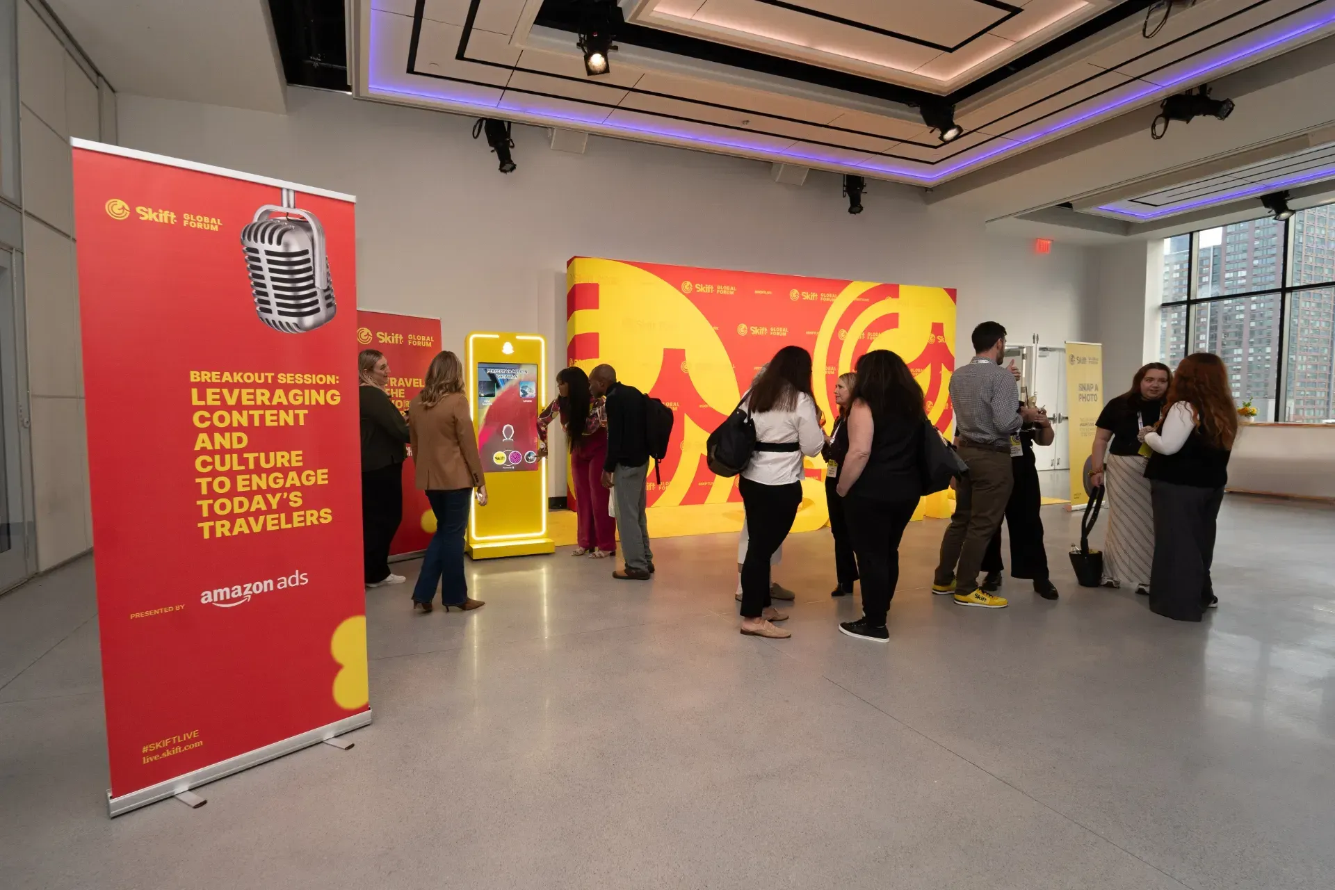 A group of people are standing in a large room.
