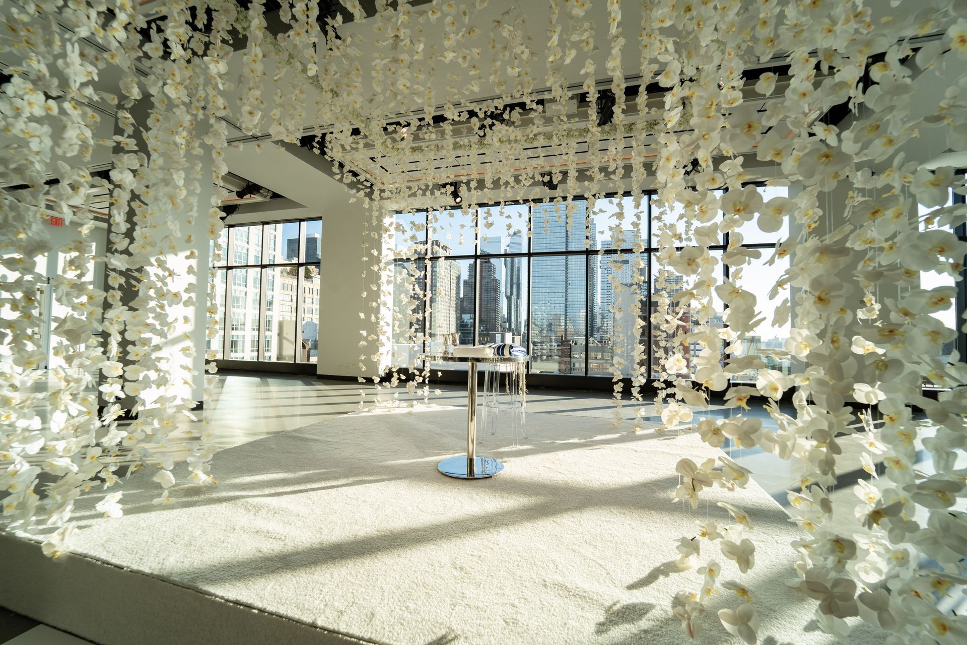 A large room with a circular dance floor and a chandelier hanging from the ceiling.