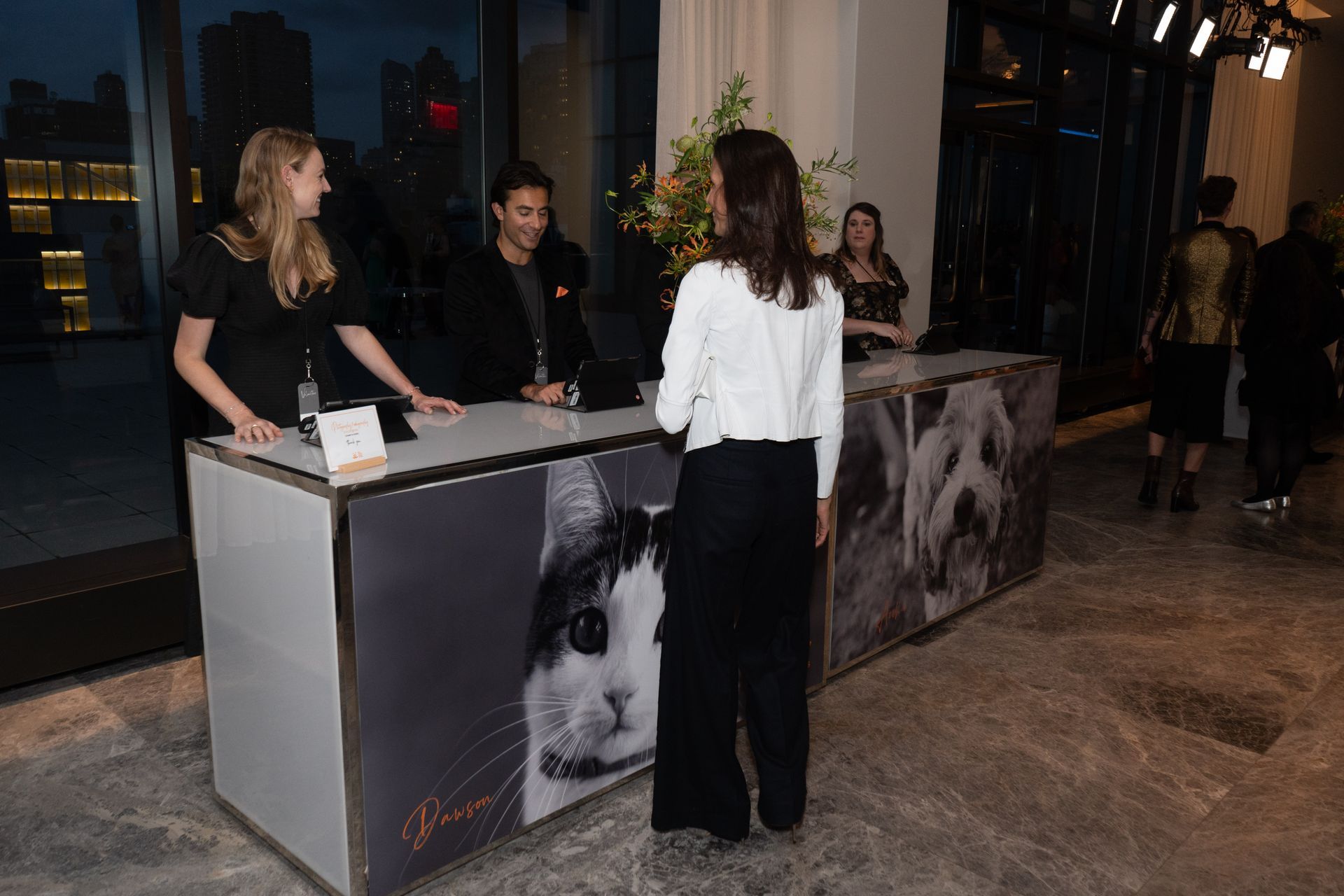 A woman is standing in front of a counter with a picture of a rabbit on it.