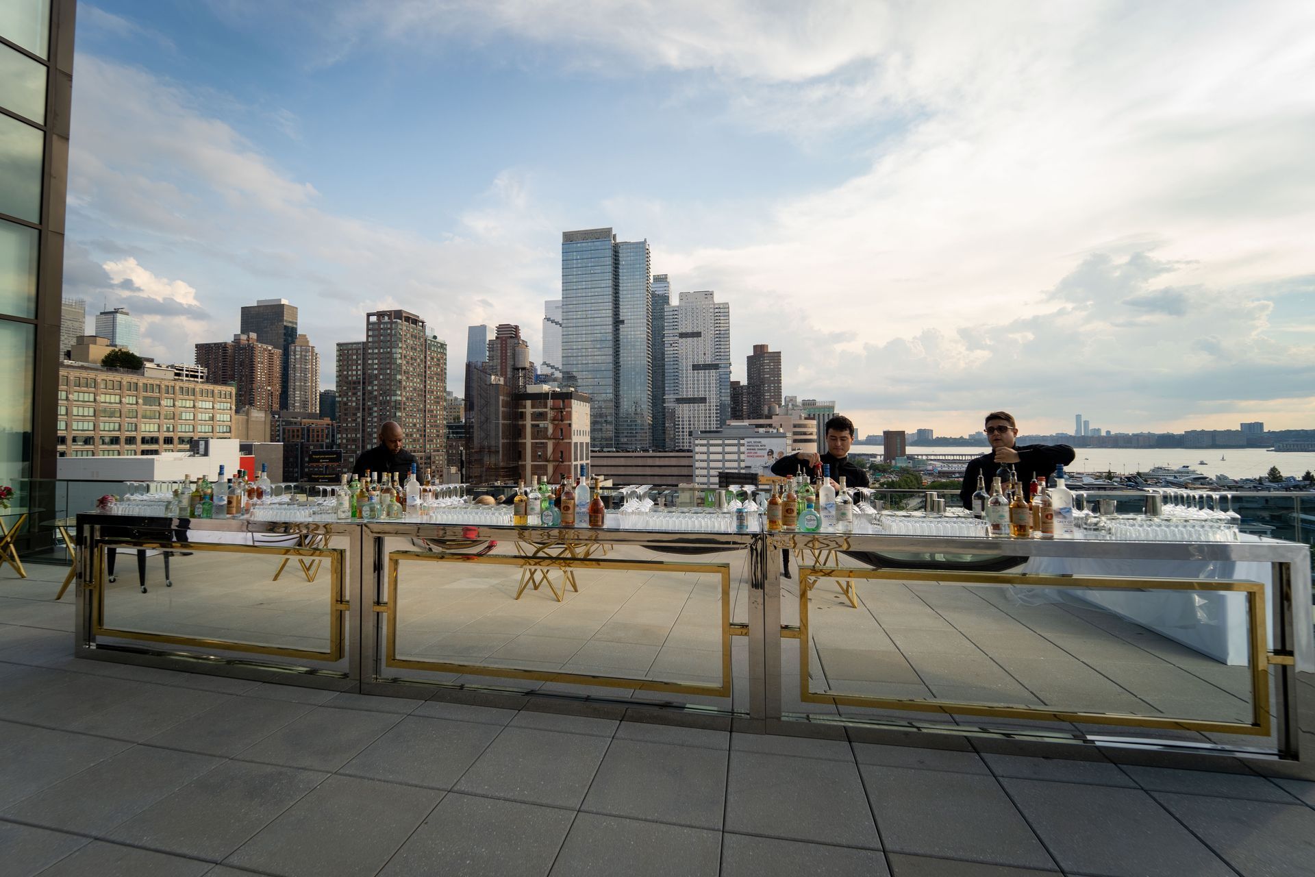 A group of people are sitting at a table with a city skyline in the background.