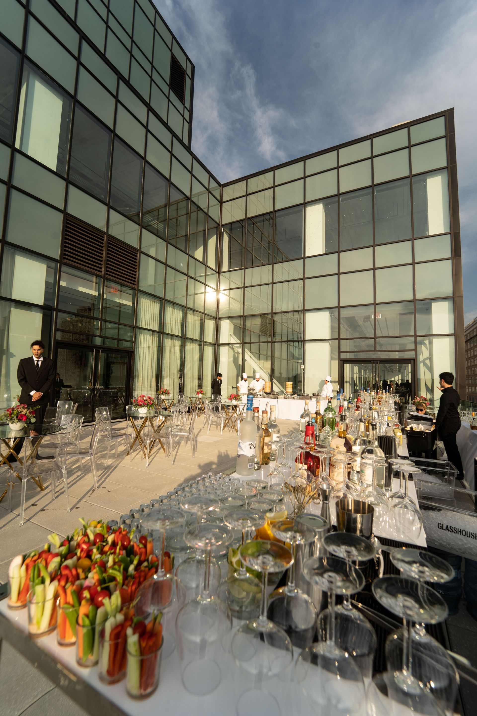 a large building with a lot of windows and a table with food and wine glasses on it