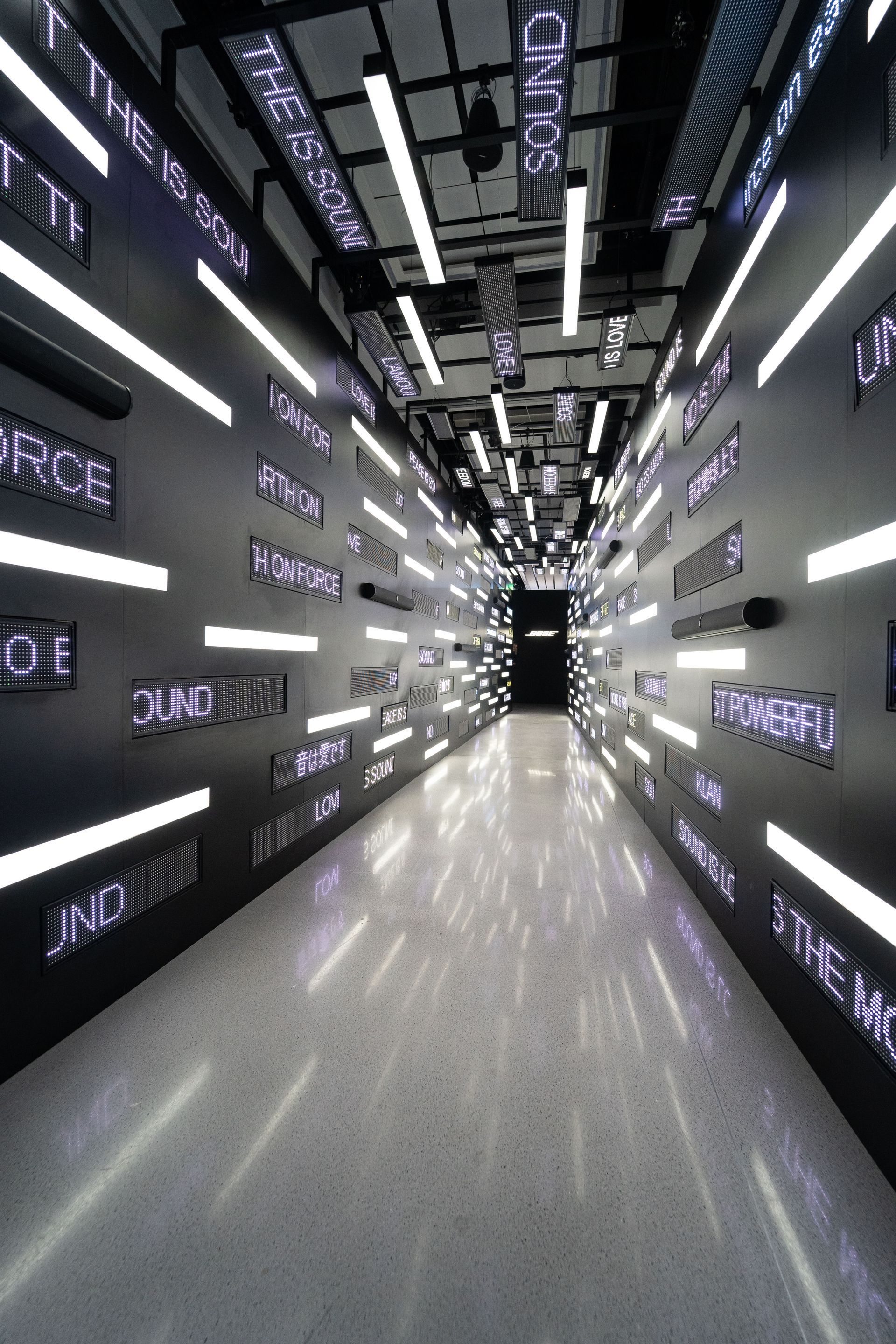 A long hallway with a lot of lights on the walls