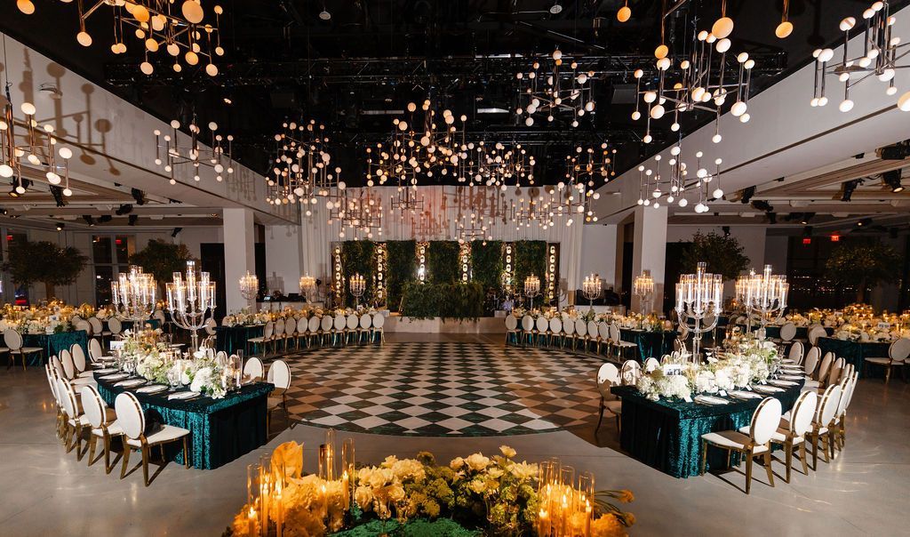 Empty modern interior with large windows, reflecting sunlight and overlooking a waterfront view.