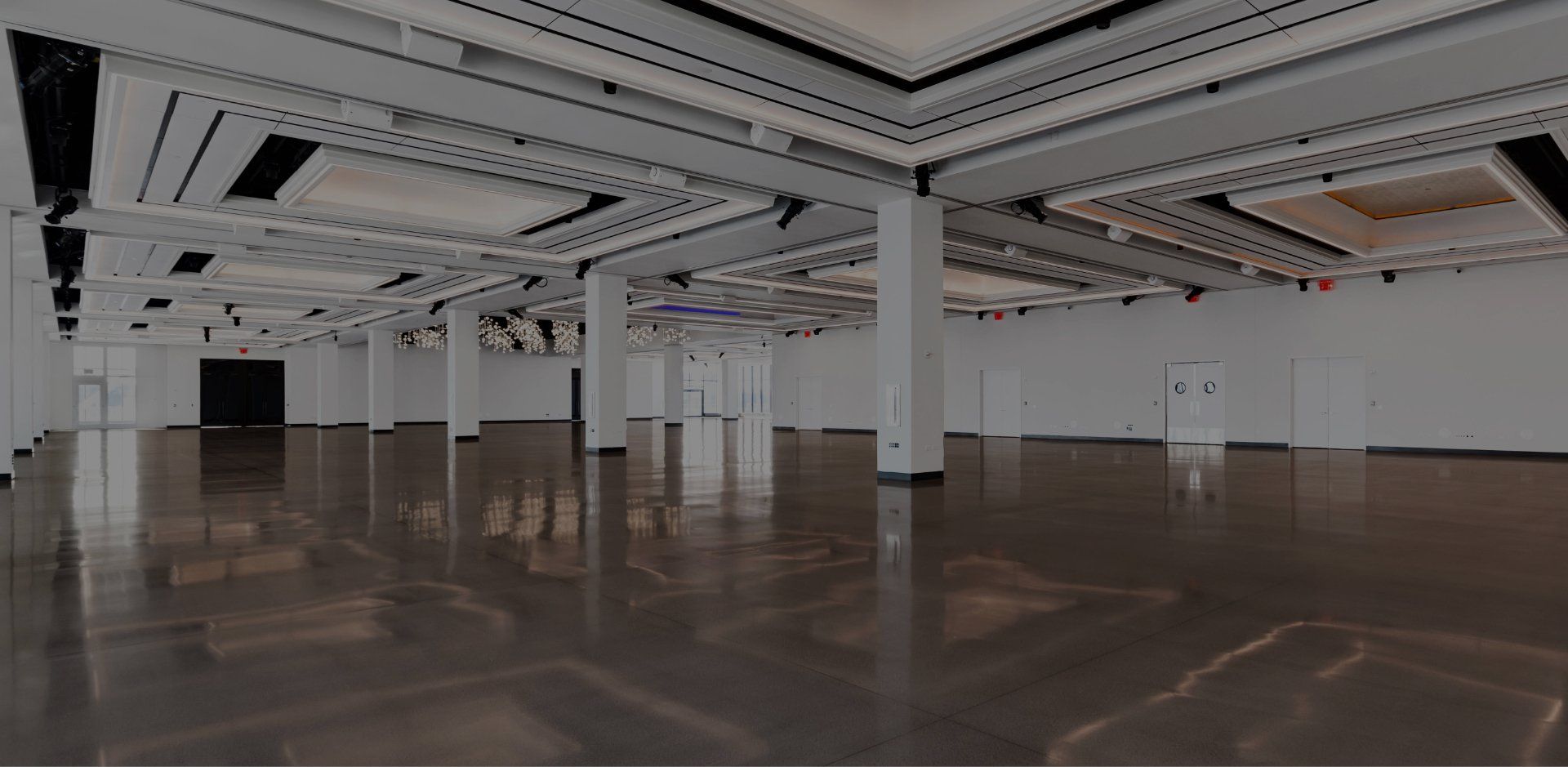 A large empty room with a shiny floor and white walls.