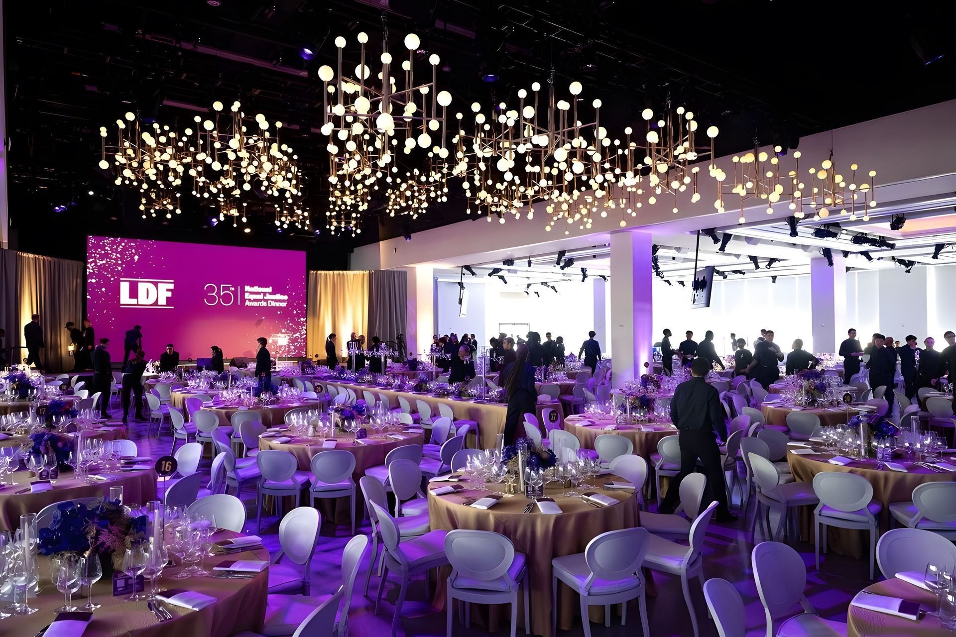 a room decorated with pink curtains and flowers for a wedding .