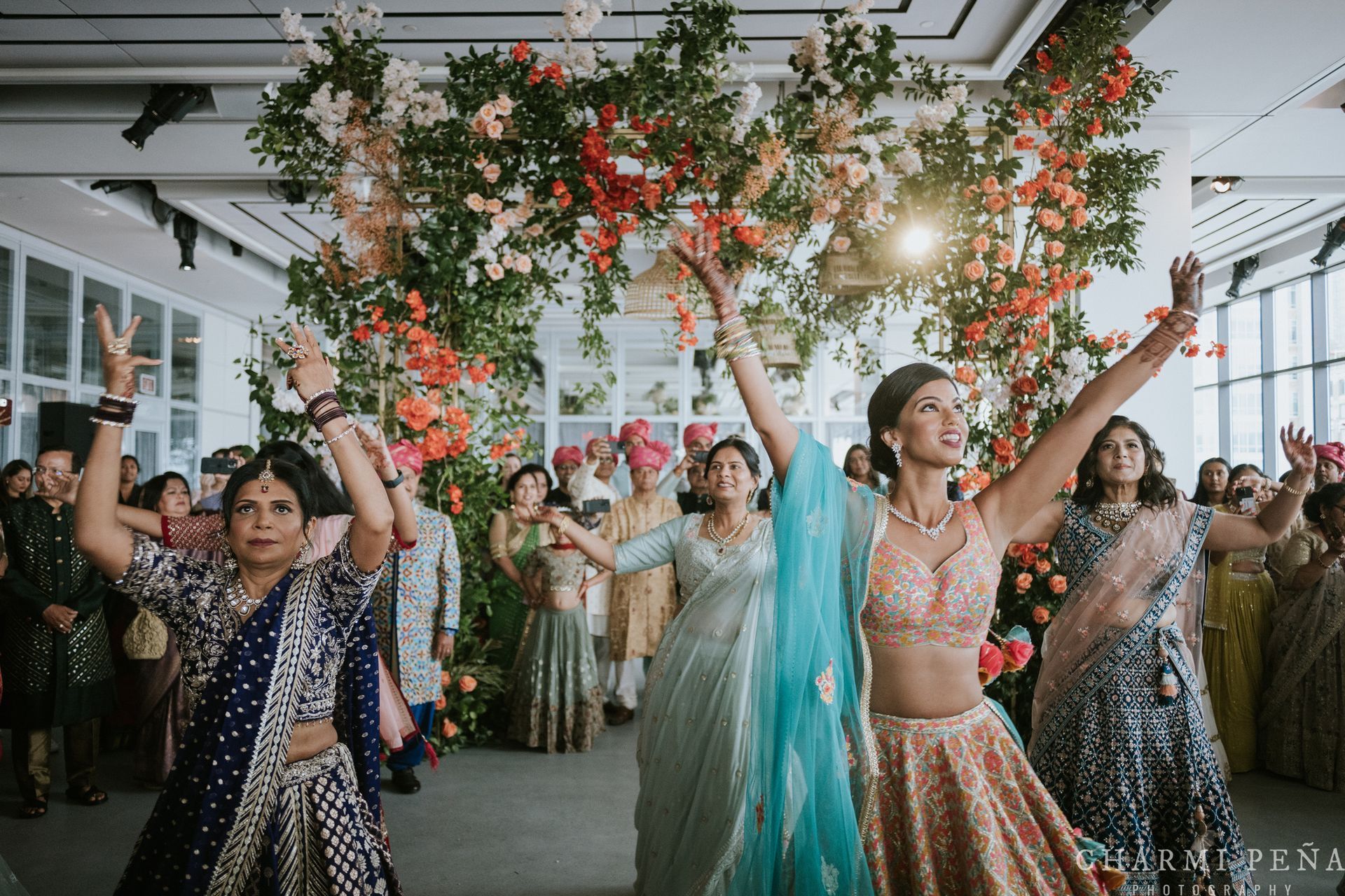 A large room with a circular dance floor and a chandelier hanging from the ceiling.