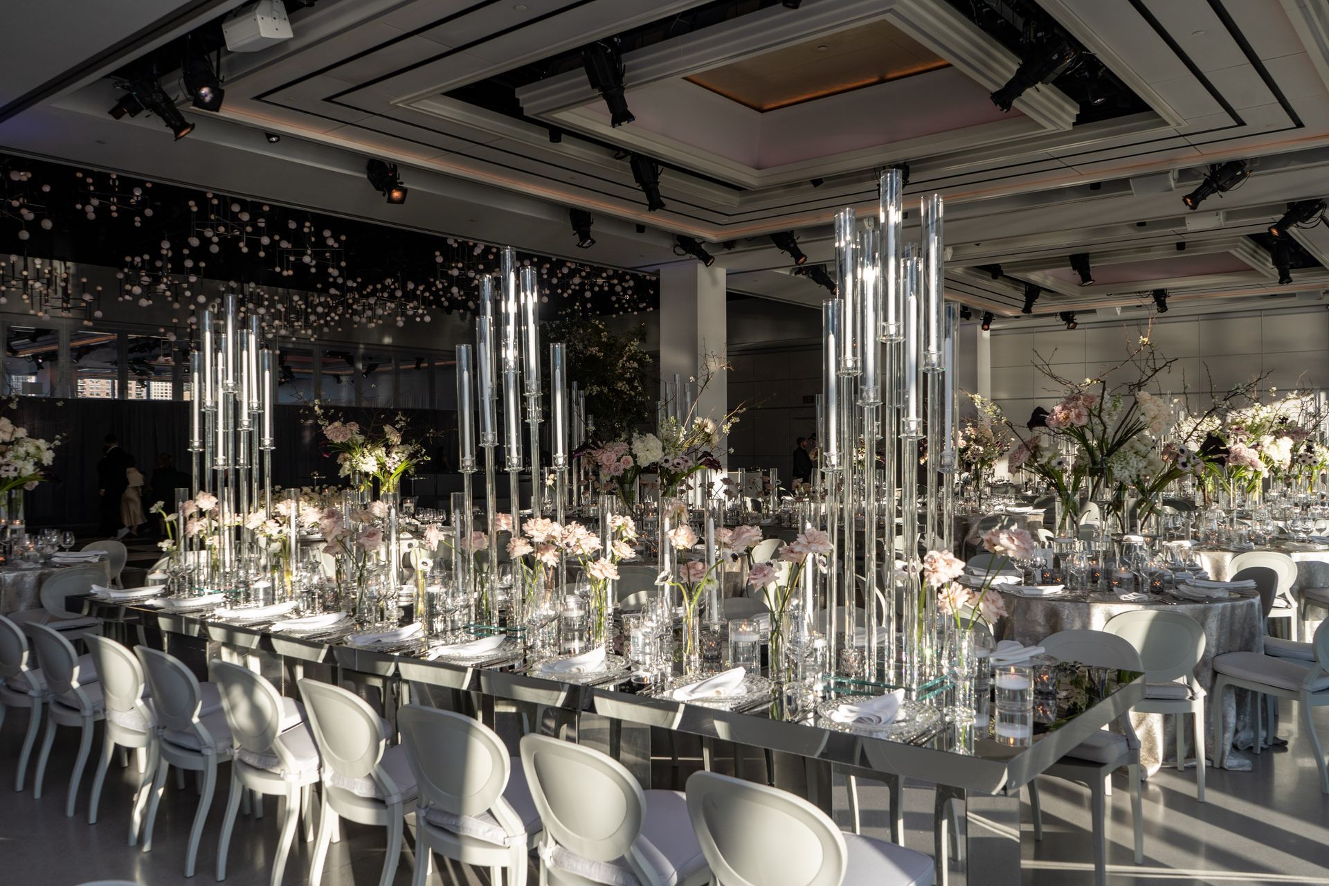 A large room with tables and chairs set up for a wedding reception.