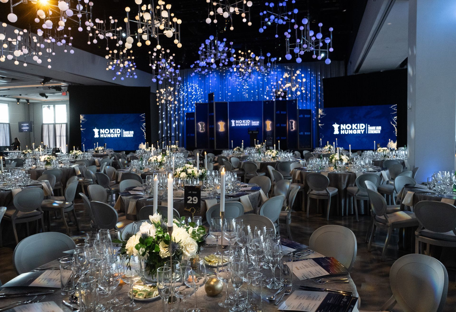 A large room with tables and chairs set up for a banquet.