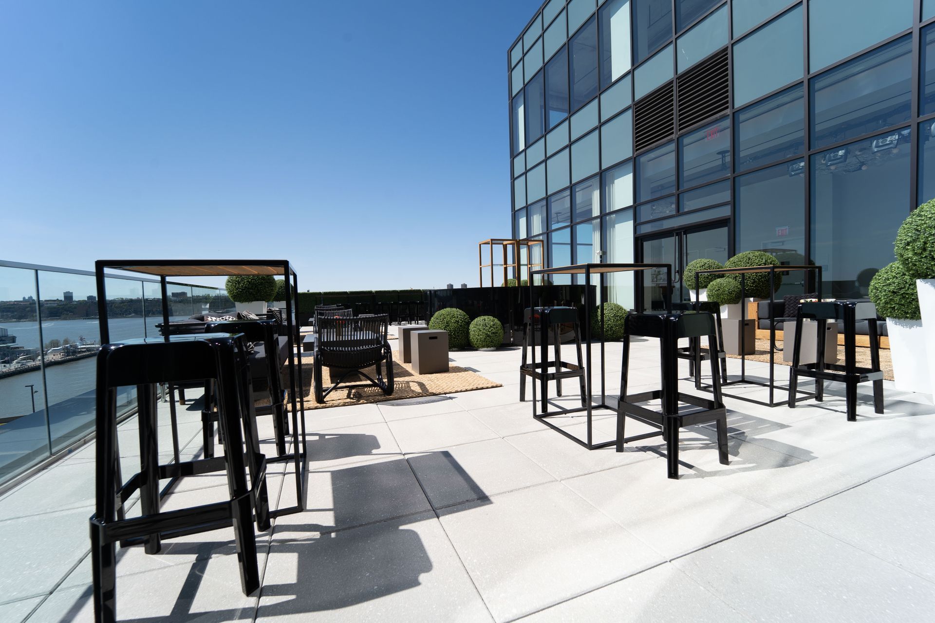 A patio with tables and chairs in front of a building.