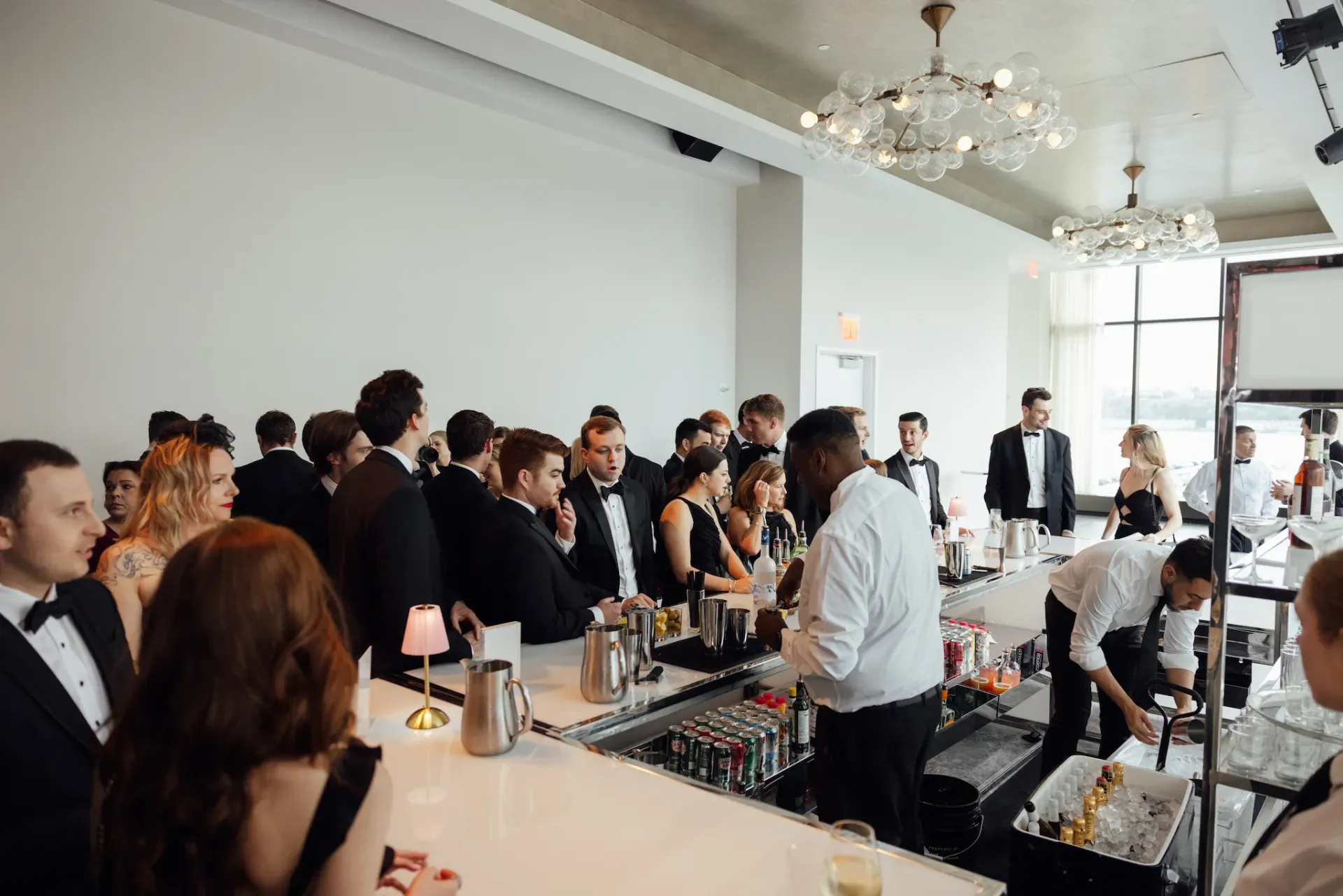 A group of people are sitting at a bar in a restaurant.