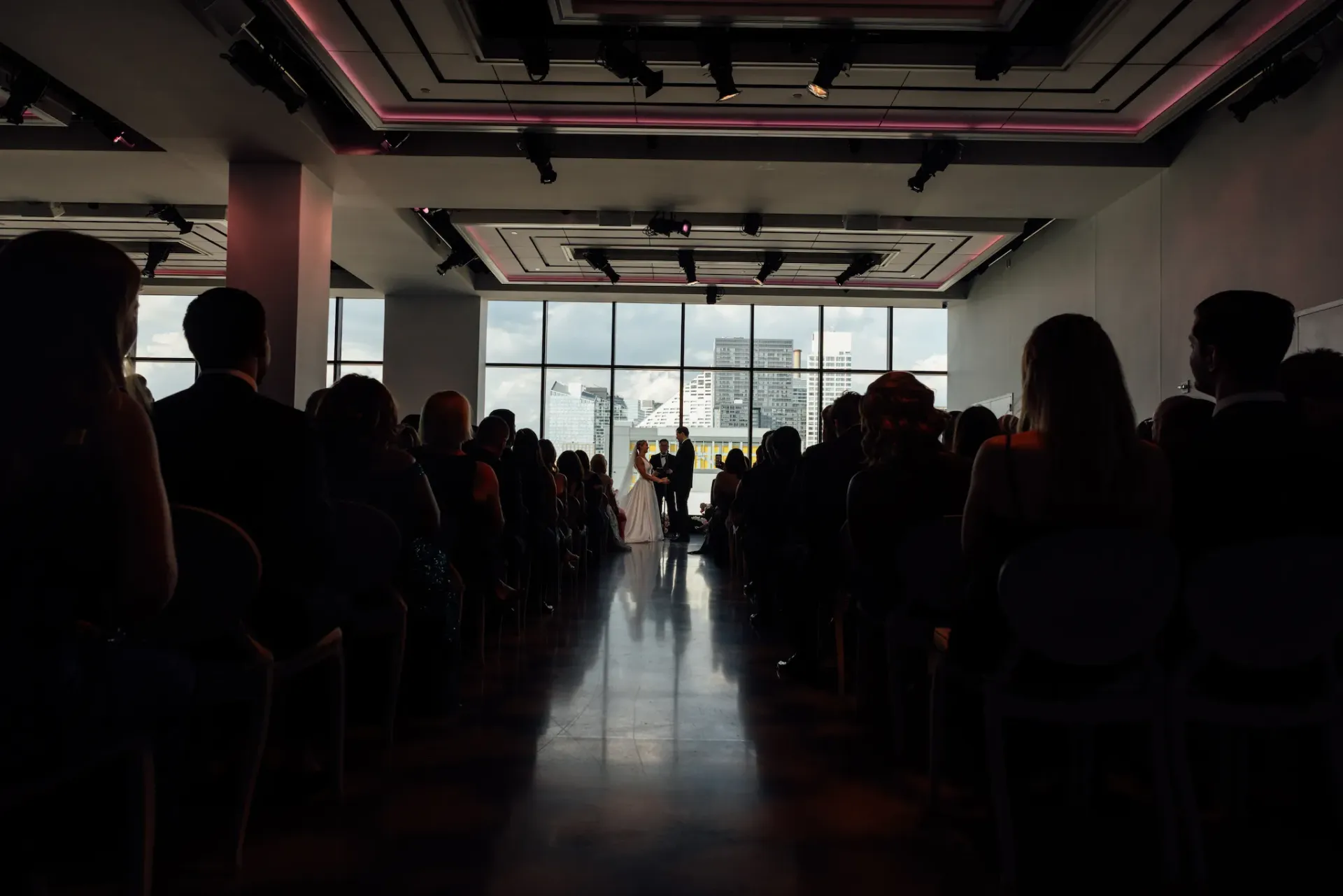A bride and groom are walking down the aisle at a wedding ceremony.