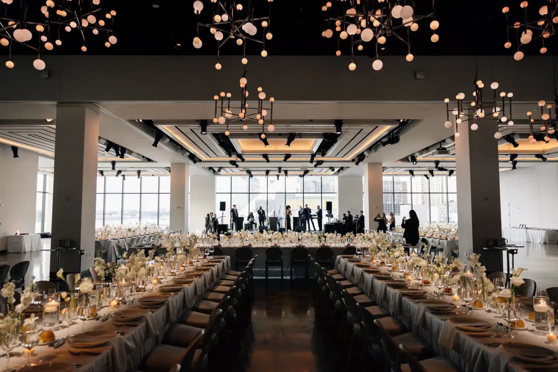 A large room with tables and chairs set up for a wedding reception.