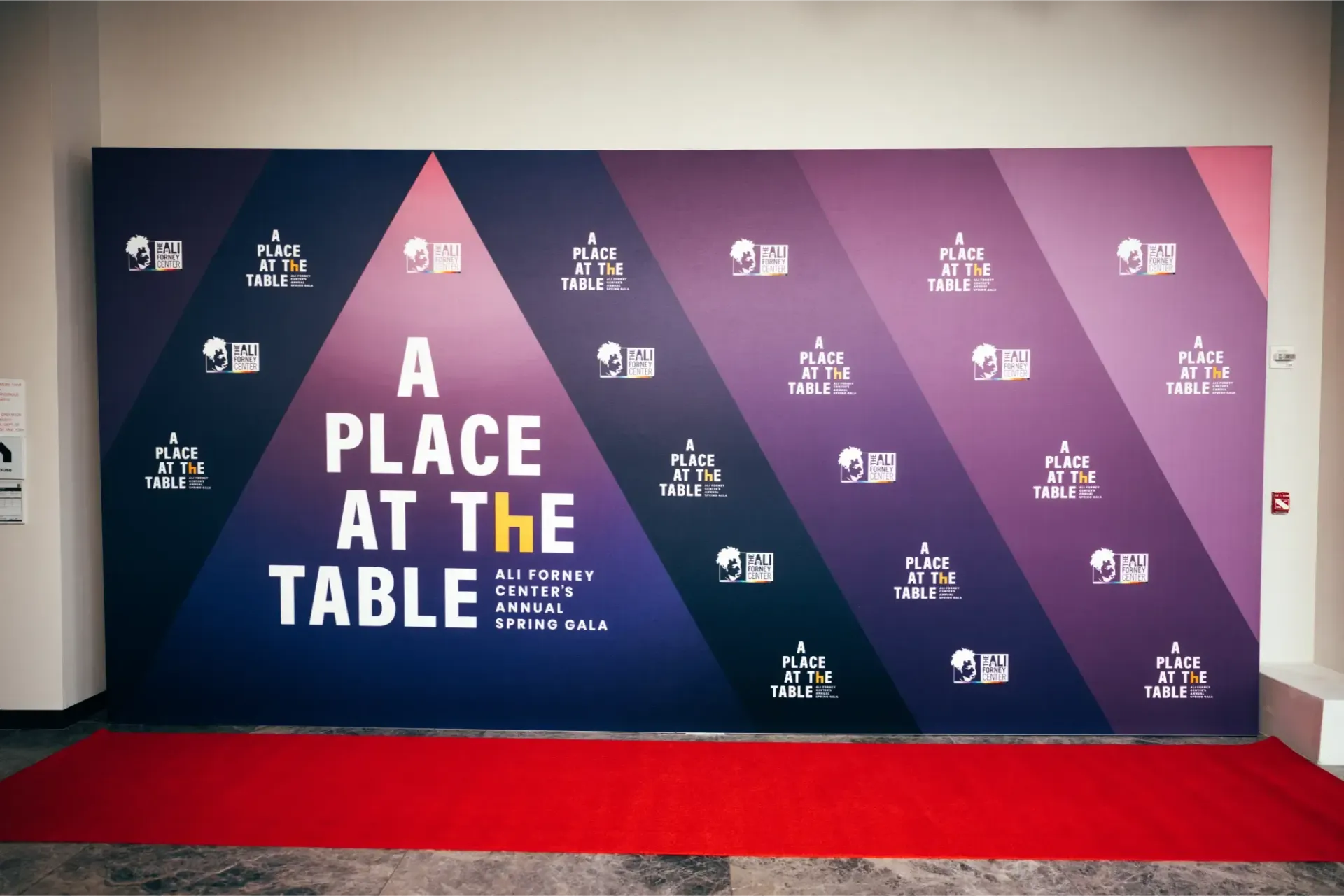 A wall that says a place at the table on it