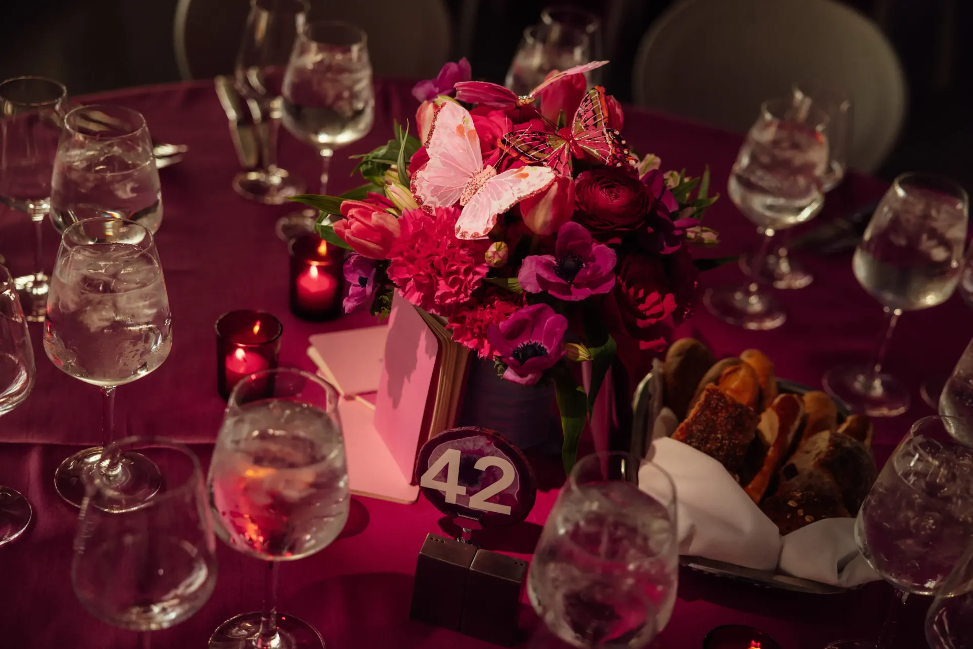 A table with a vase of flowers and a number 42 on it.
