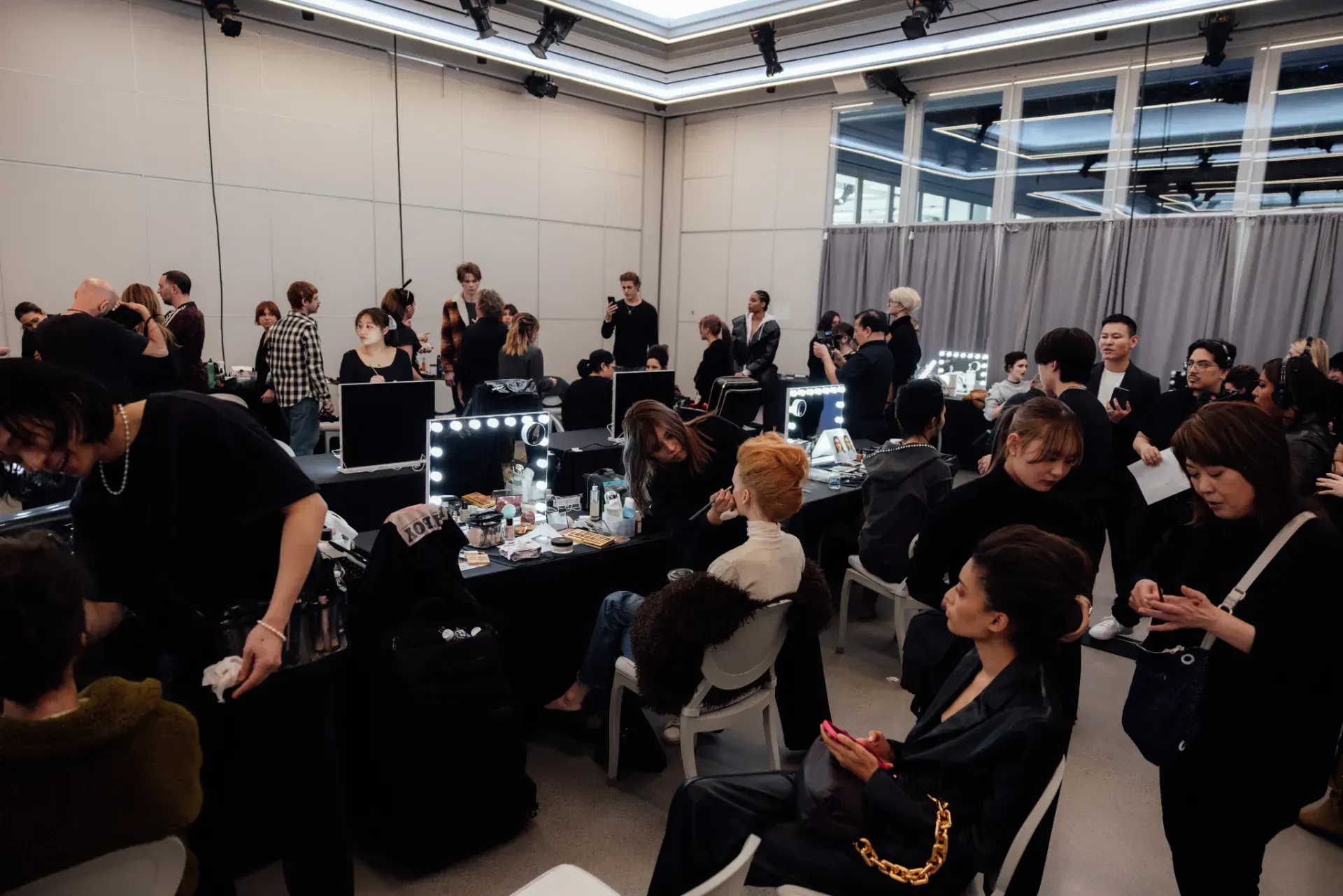 A group of people are sitting at tables in a large room.