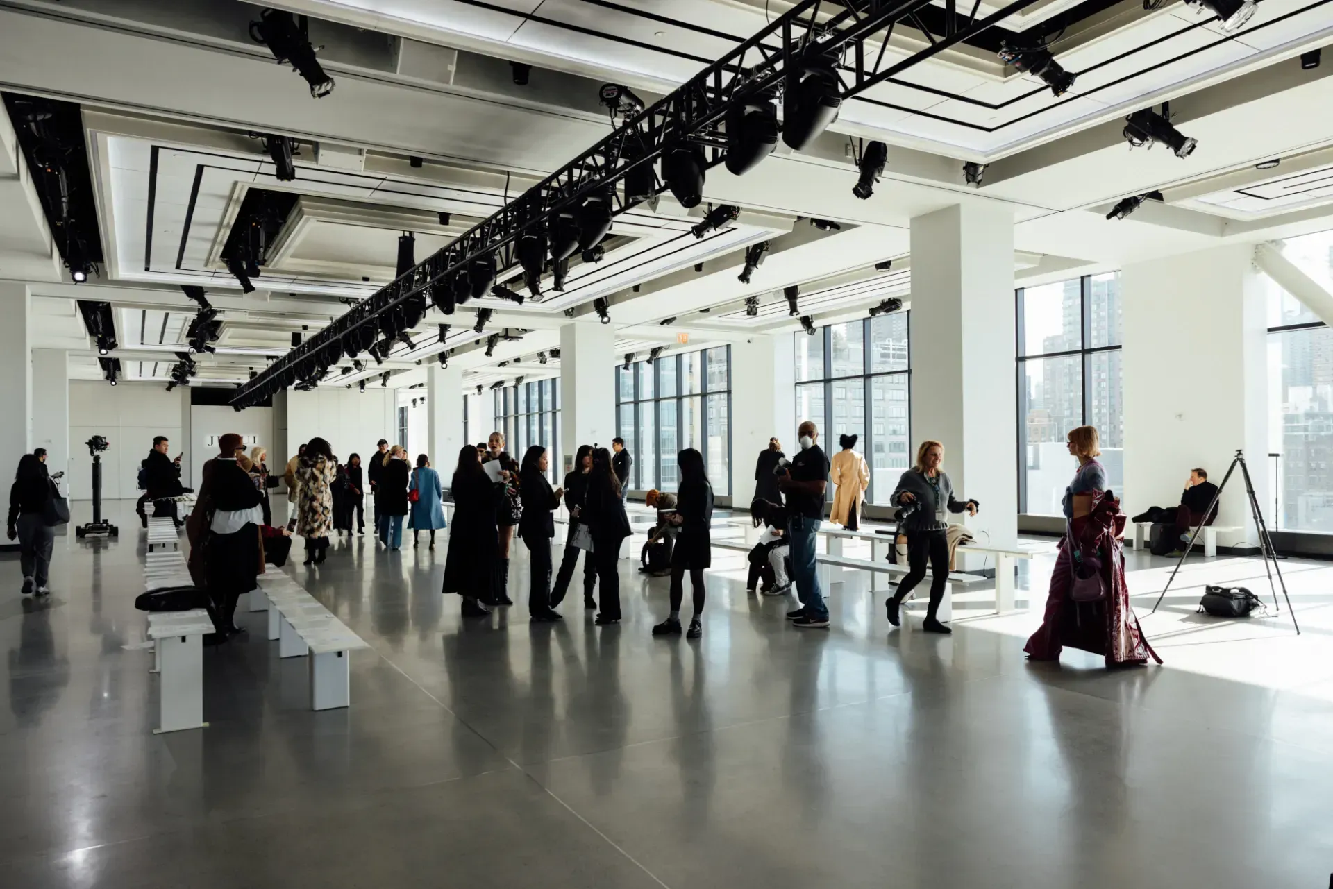 A group of people are standing in a large room.
