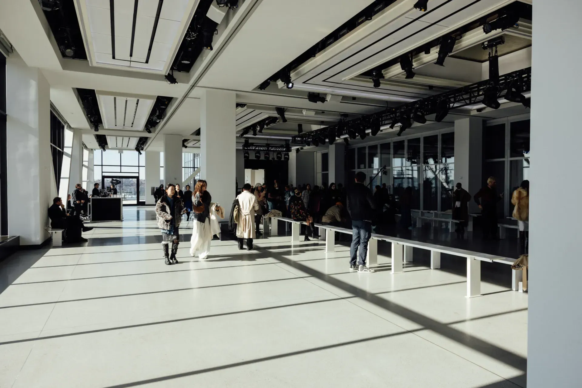 A group of people are standing in a large room.