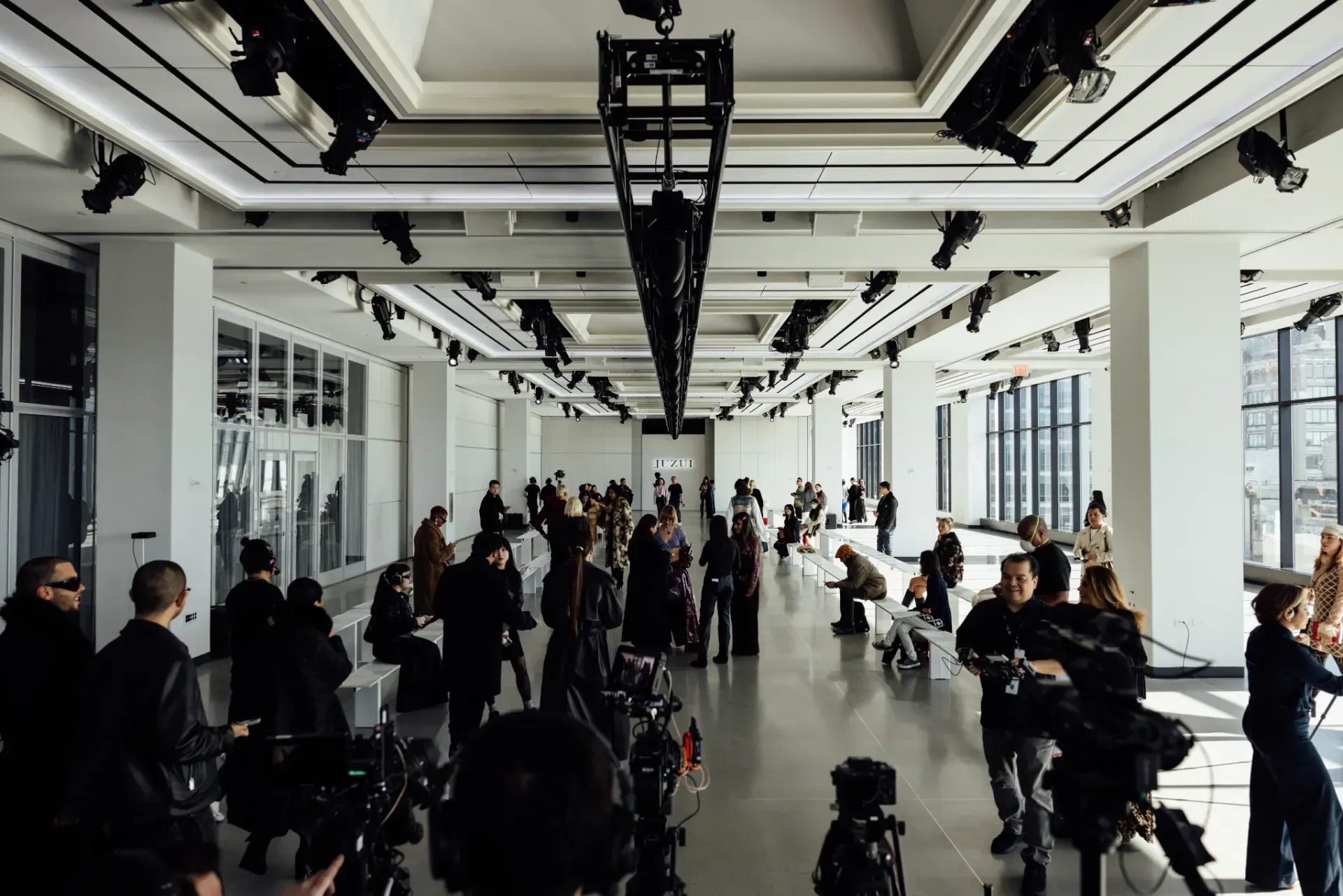 A group of people are standing in a large room.