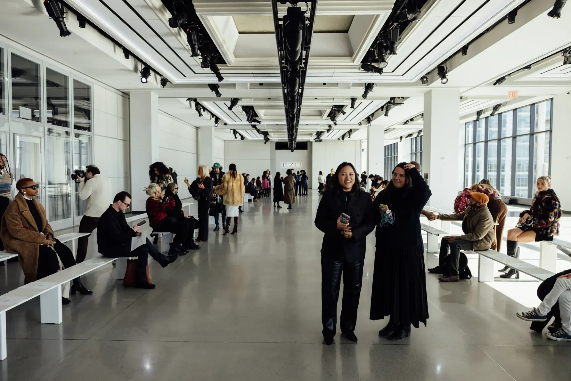 A group of people are standing in a large room.