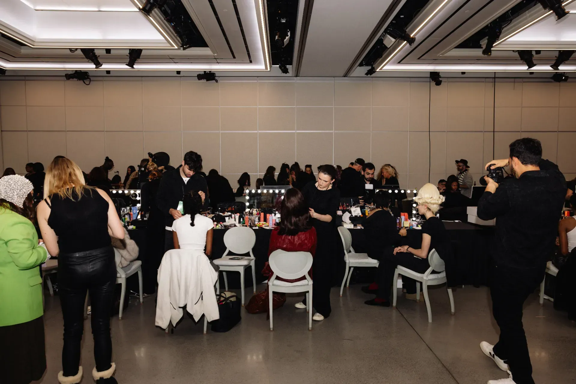 A group of people are sitting in chairs in a large room.