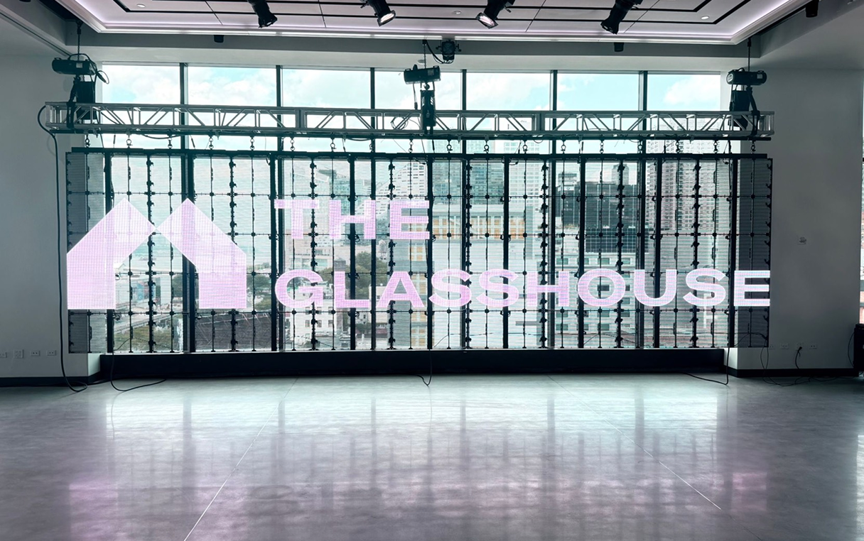 Large display with "THE GLASSHOUSE" over a window, interior view.