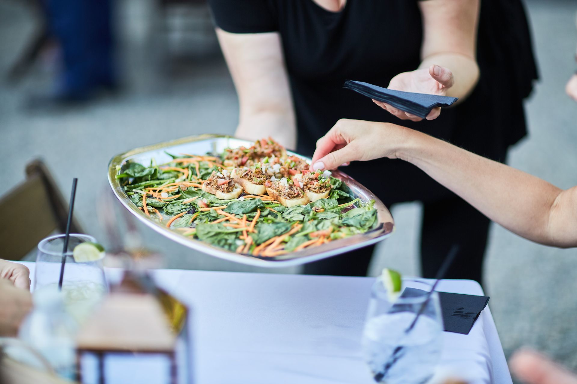A person is taking a picture of a plate of food on a table.