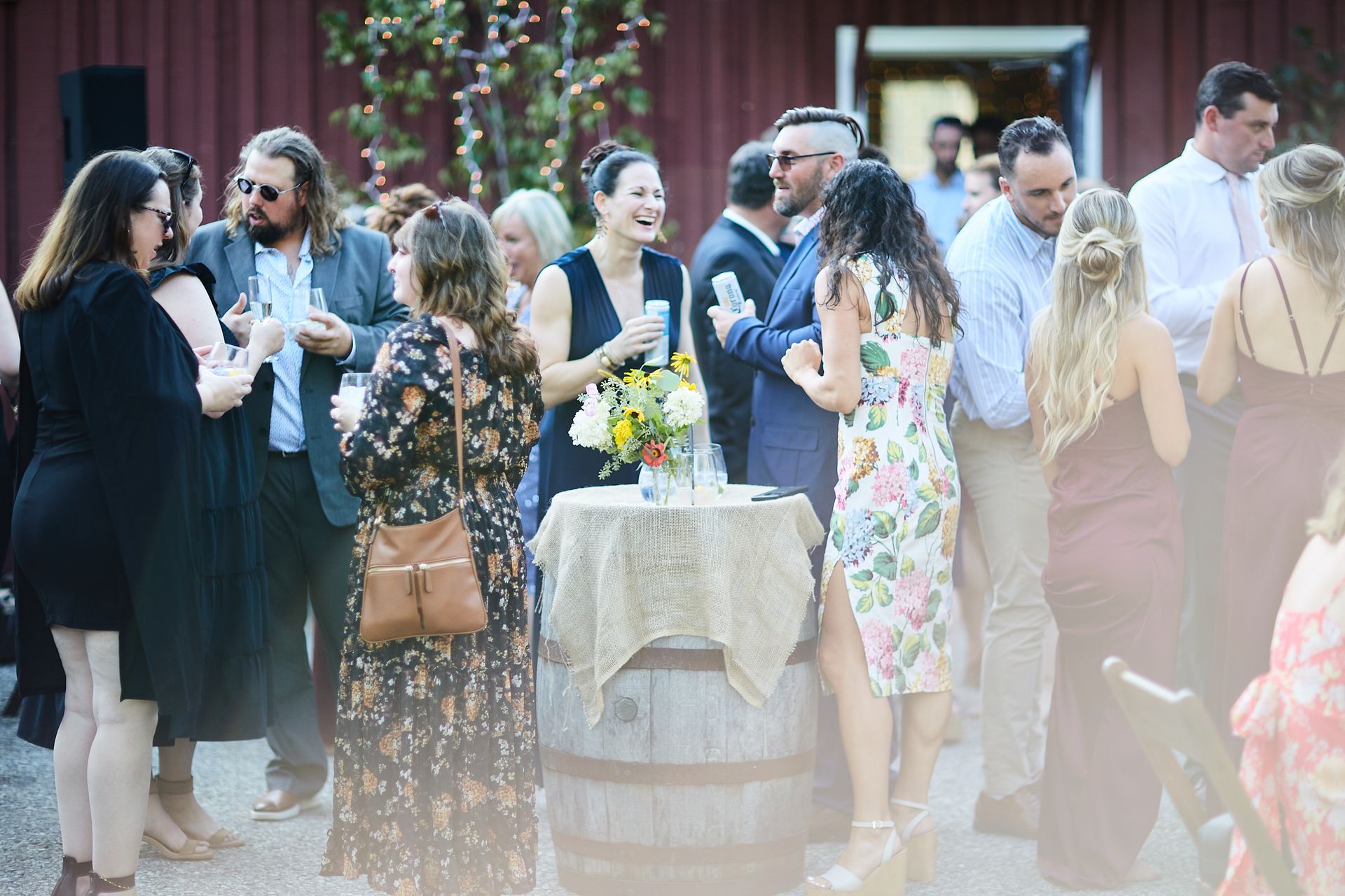 A group of people are standing around a table at a wedding reception.