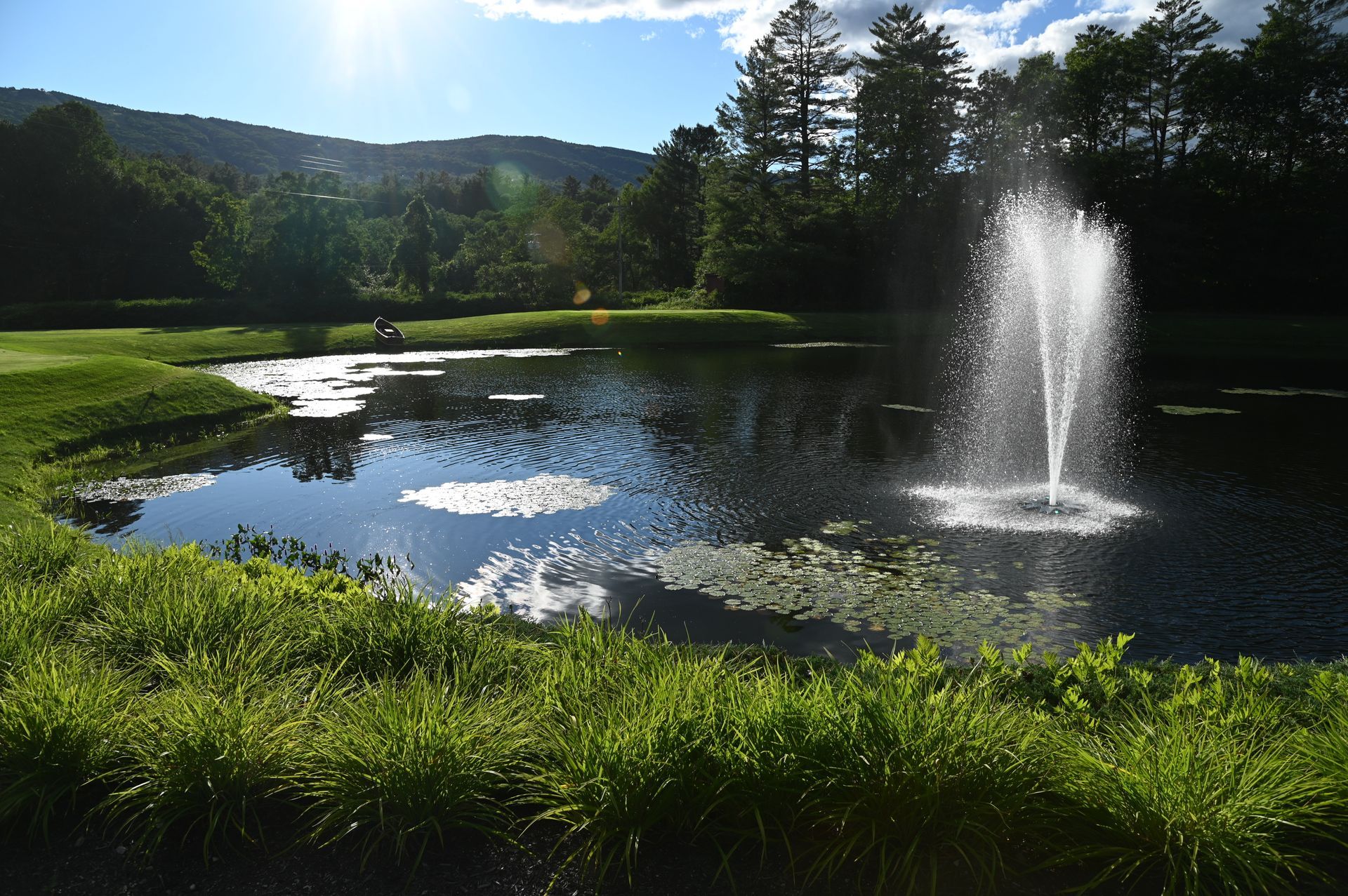 A pond with a fountain in the middle of it