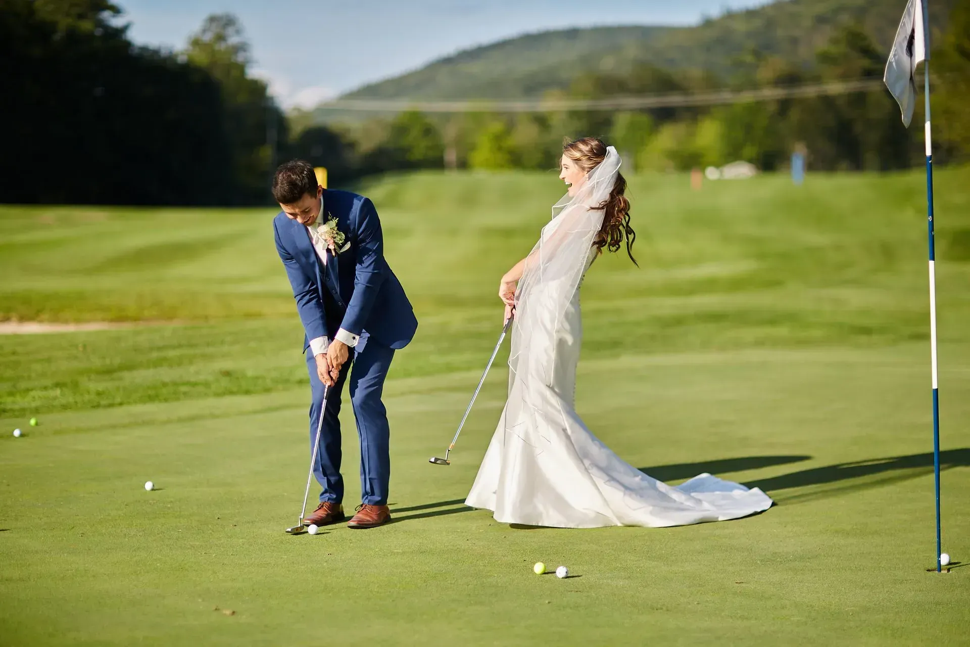 A bride and groom are playing golf on a golf course.