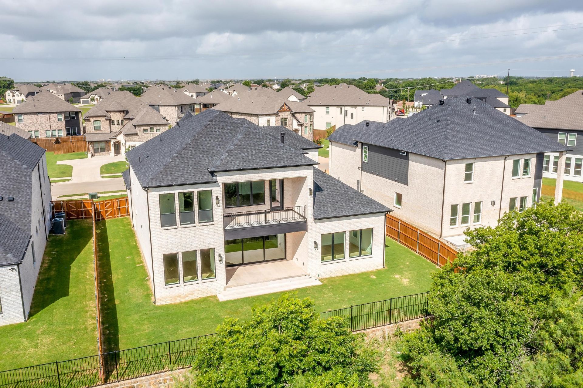 An aerial view of a residential area with lots of houses and trees.