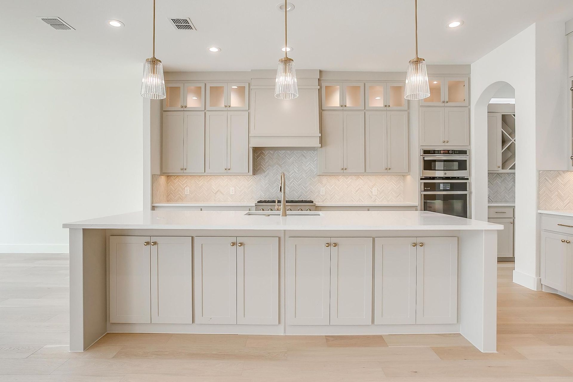 There is a large island in the middle of the kitchen.